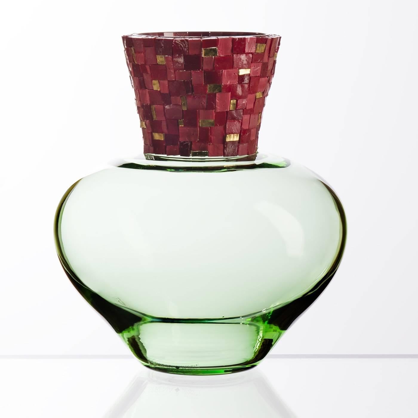 Designed and handmade in Murano using ancient techniques and precious materials, this exquisite Murano mouth-blown glass vase has a delicate green base with a richly accented neck. The mosaic is made of gold foil tesserae and opaque and transparent