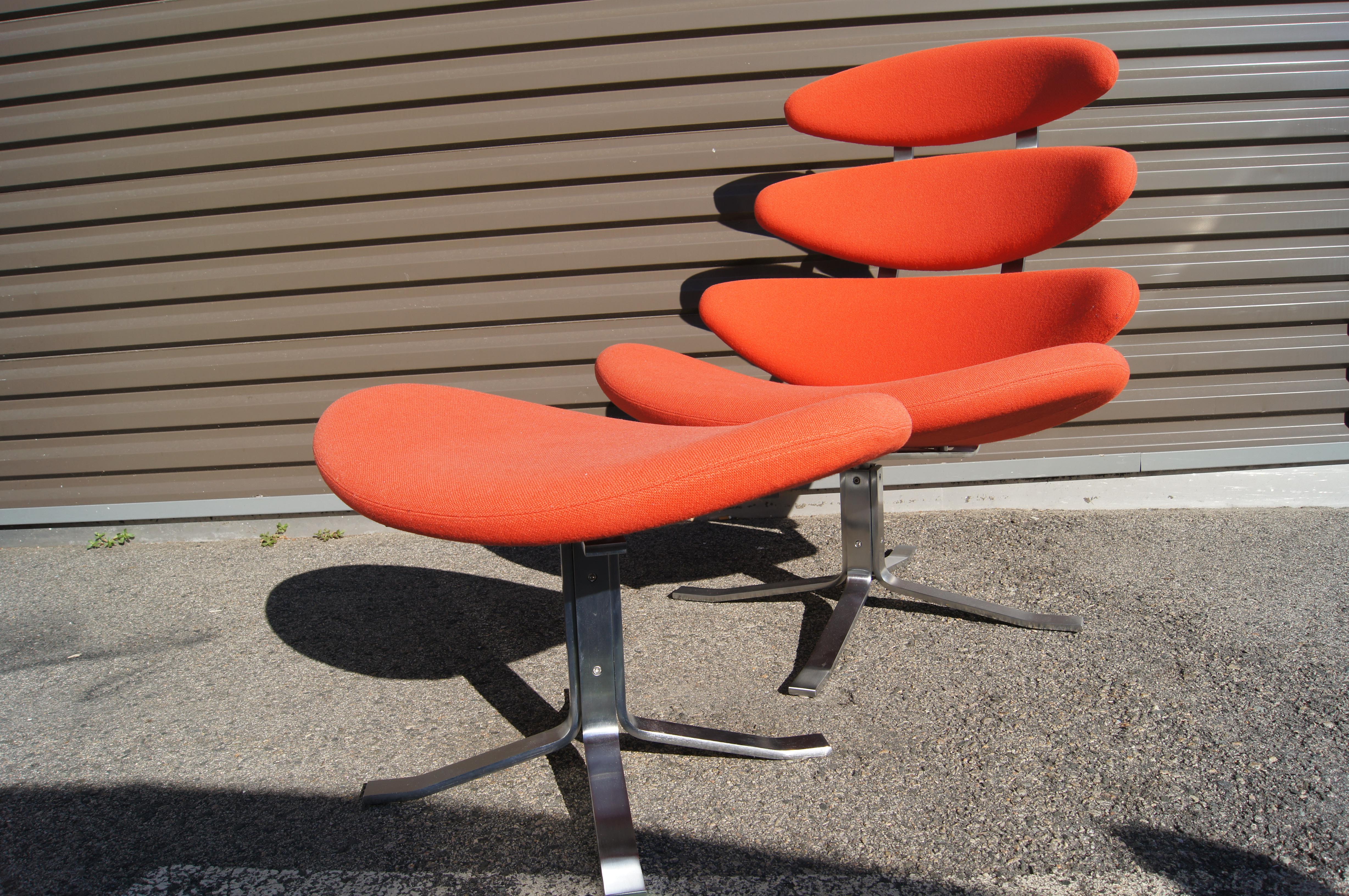 Poul M. Volther designed the classic Corona Chair for Erik Jørgensen in 1964. Four padded cushions, here in a vibrant orange, ascend a stainless-steel frame that swivels, creating a lounge chair that is both comfortable and visually