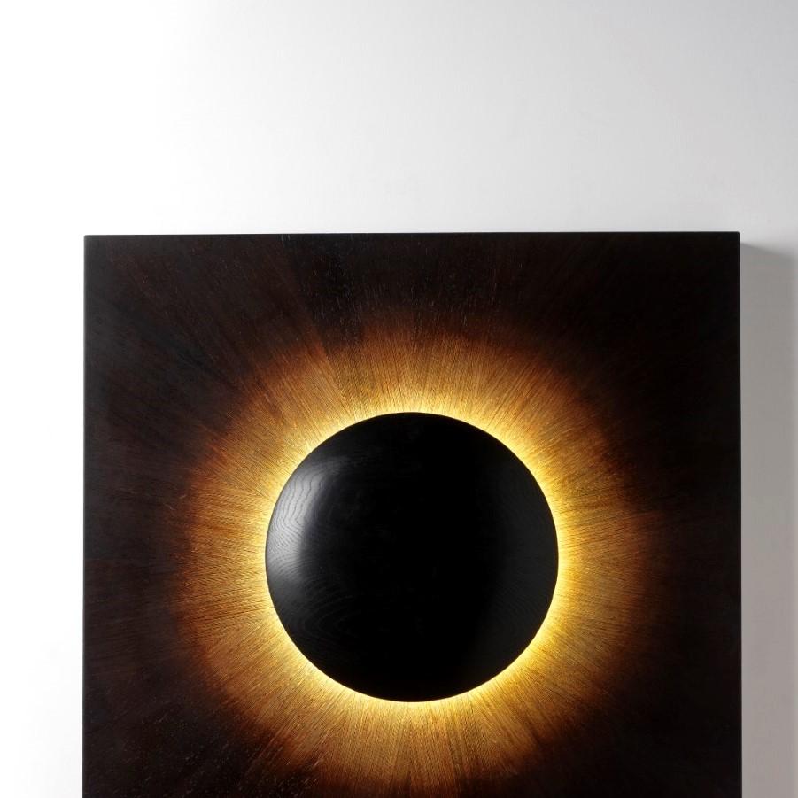 Corona wall art by David Tragen
Limited Edition of 12
Dimensions: W 90 x D 90 x H 55 cm
Materials: Bleached and coloured Wenge, Ebonised Oak, LEDs
Dimensions can be customized.

Inspired by the 2015 solar eclipse, Corona captures that magical