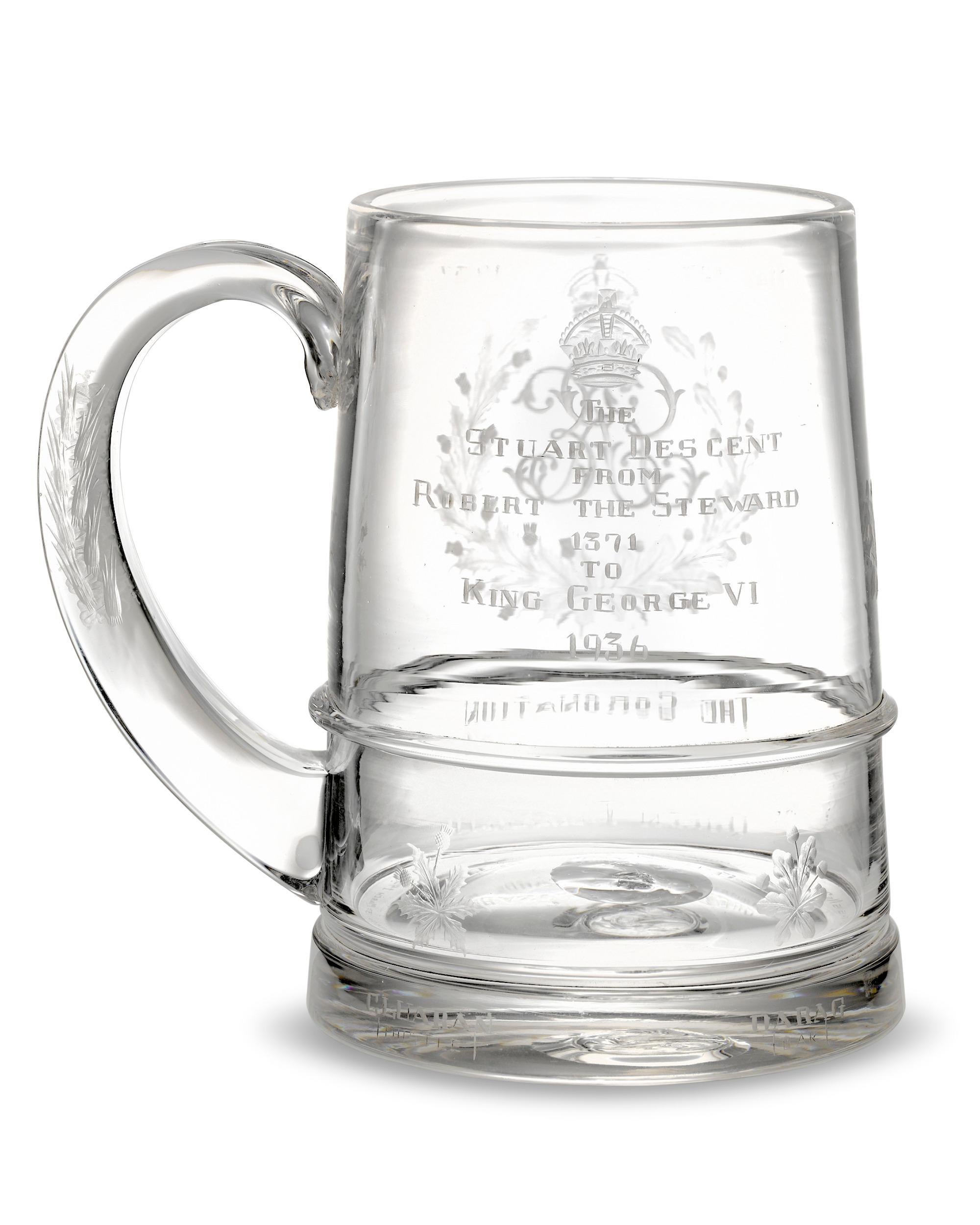 Intricate engravings symbolic of the English monarchy decorate this limited edition glass tankard commemorating the 1937 coronation of King George VI and Queen Elizabeth. On one side, the king's crowned monogram is framed by oak and thistle foliage
