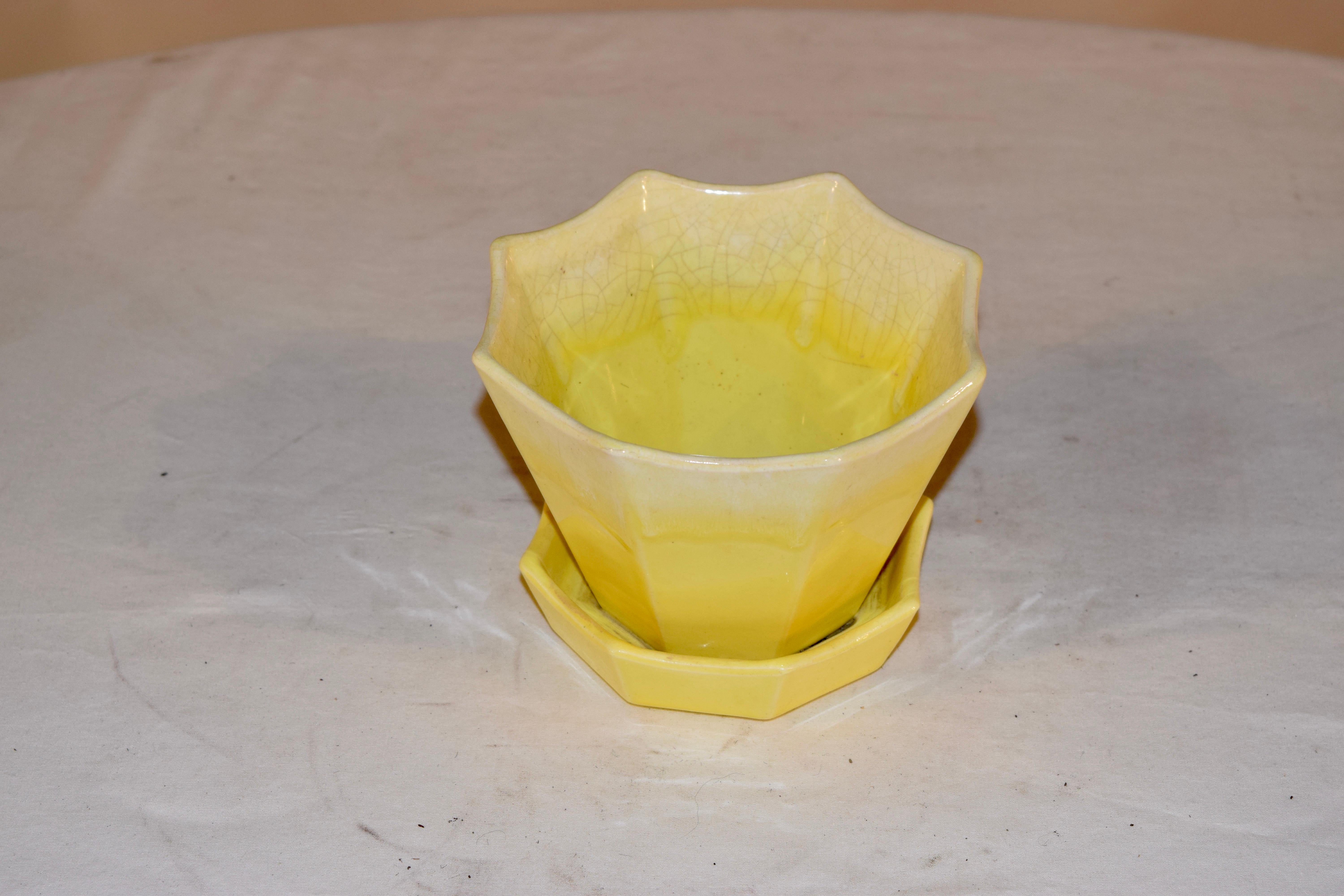 Signed coronet flower pot with attached saucer with a drain hole in a lovely yellow which is lighter at the top and gets darker as it goes down. It has a star shape and is stamped Coronet 201 USA on the bottom.