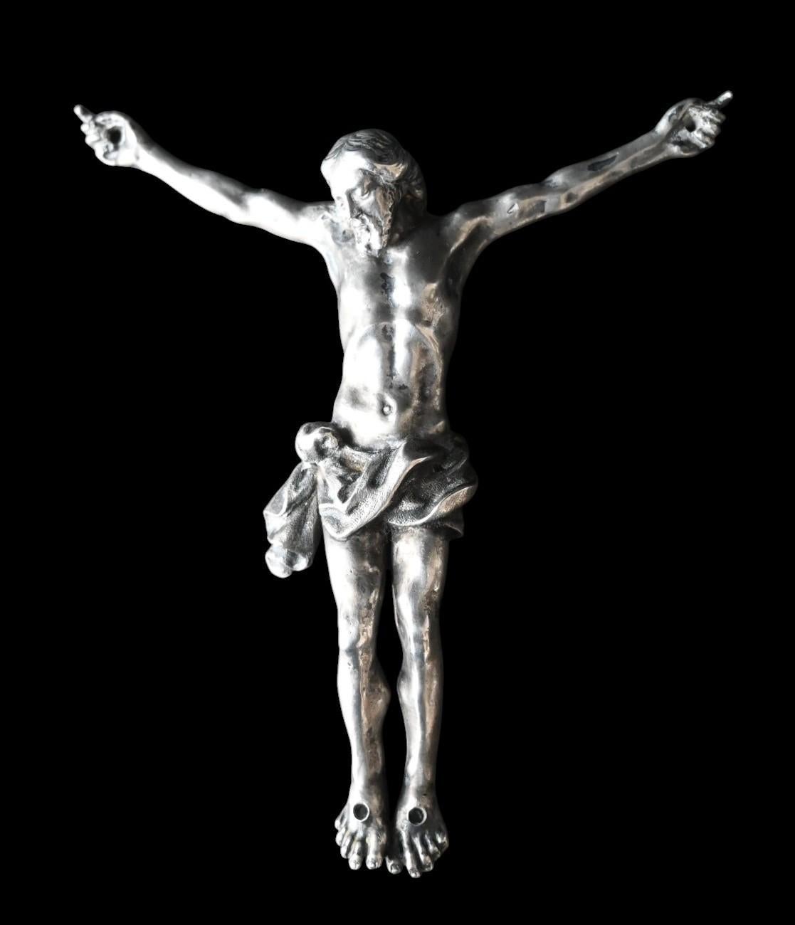 Solid Silver Corpus of Christ – Mid-18th Century
Height: 13 cm (head to toe)
Width: 12 cm (hand to hand)
Weight: 150 g

A finely cast and chased solid silver corpus depicting Christ crucified, dating to the mid-18th century (circa 1740–1760). The