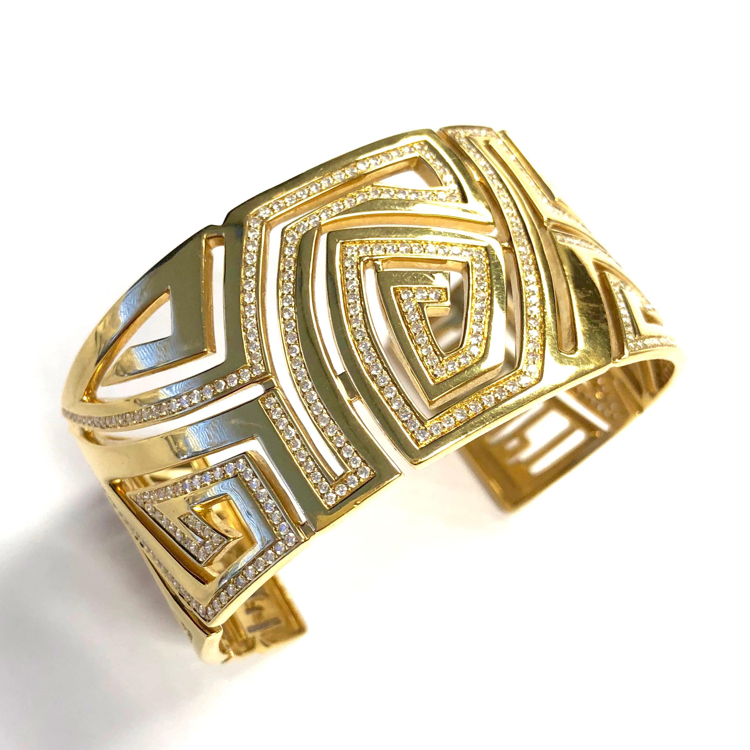 Amazing piece by corrupt design Jewelry, New York. Crafted in 18K yellow gold, the wide cuff bracelet features a cut-out design of diamond set geometric patterns, The company's name is also spelled out and set with diamonds at the ends. 
Approximate