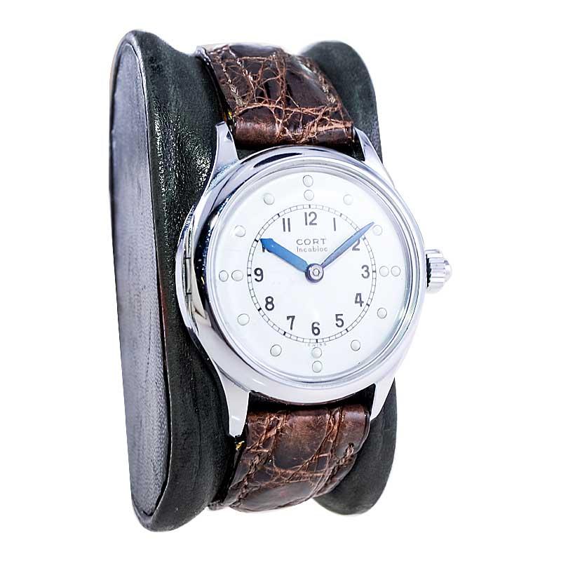 FACTORY / HOUSE: Cort Watch Company
STYLE / REFERENCE: Hunters Case / Blind Reading Dial
METAL / MATERIAL: Chromium 
DIMENSIONS: Length 40mm X Diameter 33mm
CIRCA: 1940 / 1950
MOVEMENT / CALIBER: Manual Winding / 17 Jewels 
DIAL / HANDS: Kiln Fired