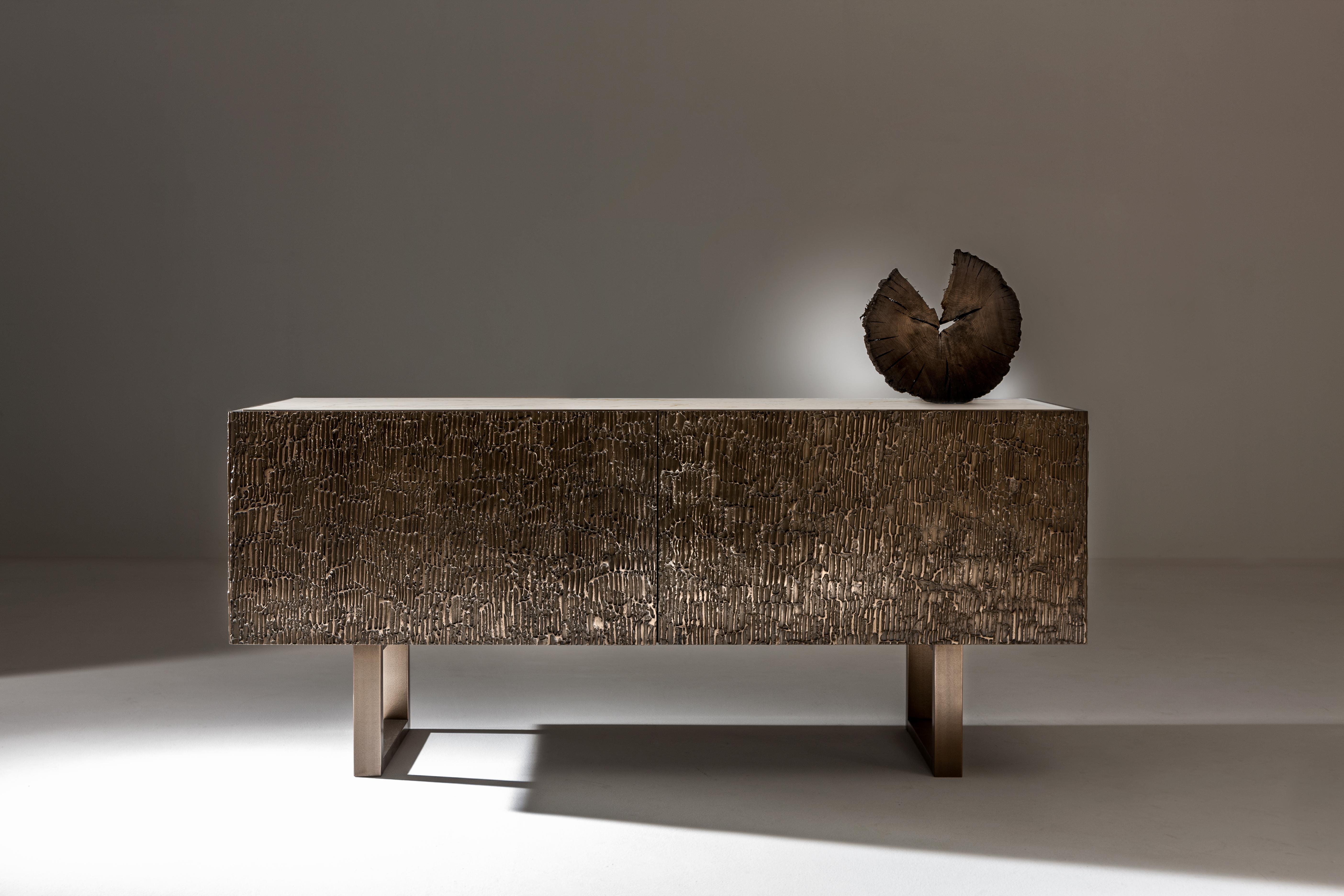 Corteccia Sideboard by Laurameroni
Dimensions: W 200 x D 50 x H 80 cm
Materials: Liquid Metal Bronze on Corteccia carving; white Carrara top; internal Termocotto Oak.

Sideboard with Corteccia carved flap doors and structure covered in liquid metal