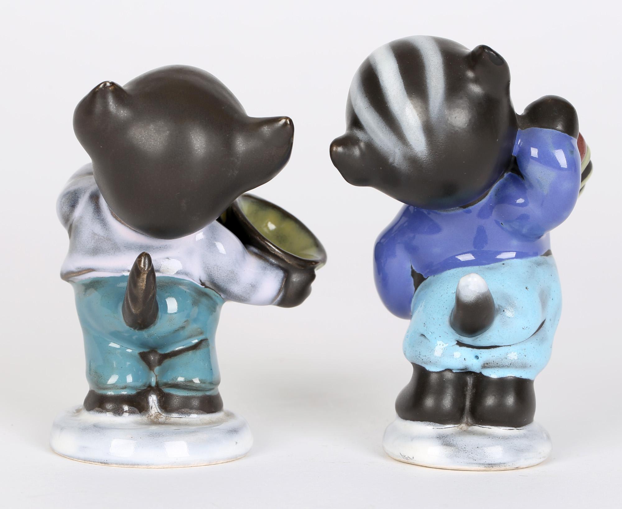 A delightful pair mid-century German novelty pottery cat musician figures made by Cortendorf in Bavaria. The cats stand on rounded bases with one playing a squeeze box and the other a horn. They are nicely depicted wearing trousers, shirt and jacket