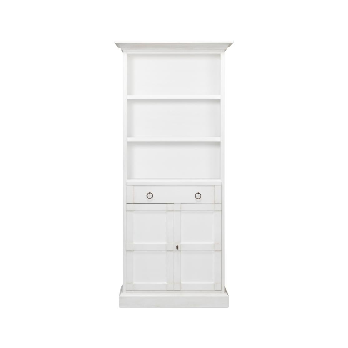 This stately piece stands tall in Cortina white, offering three open shelves that are perfect for displaying your favorite books, photos, or collectibles. Below, the twin drawers with chic ring pulls provide a safe haven for smaller items, while the