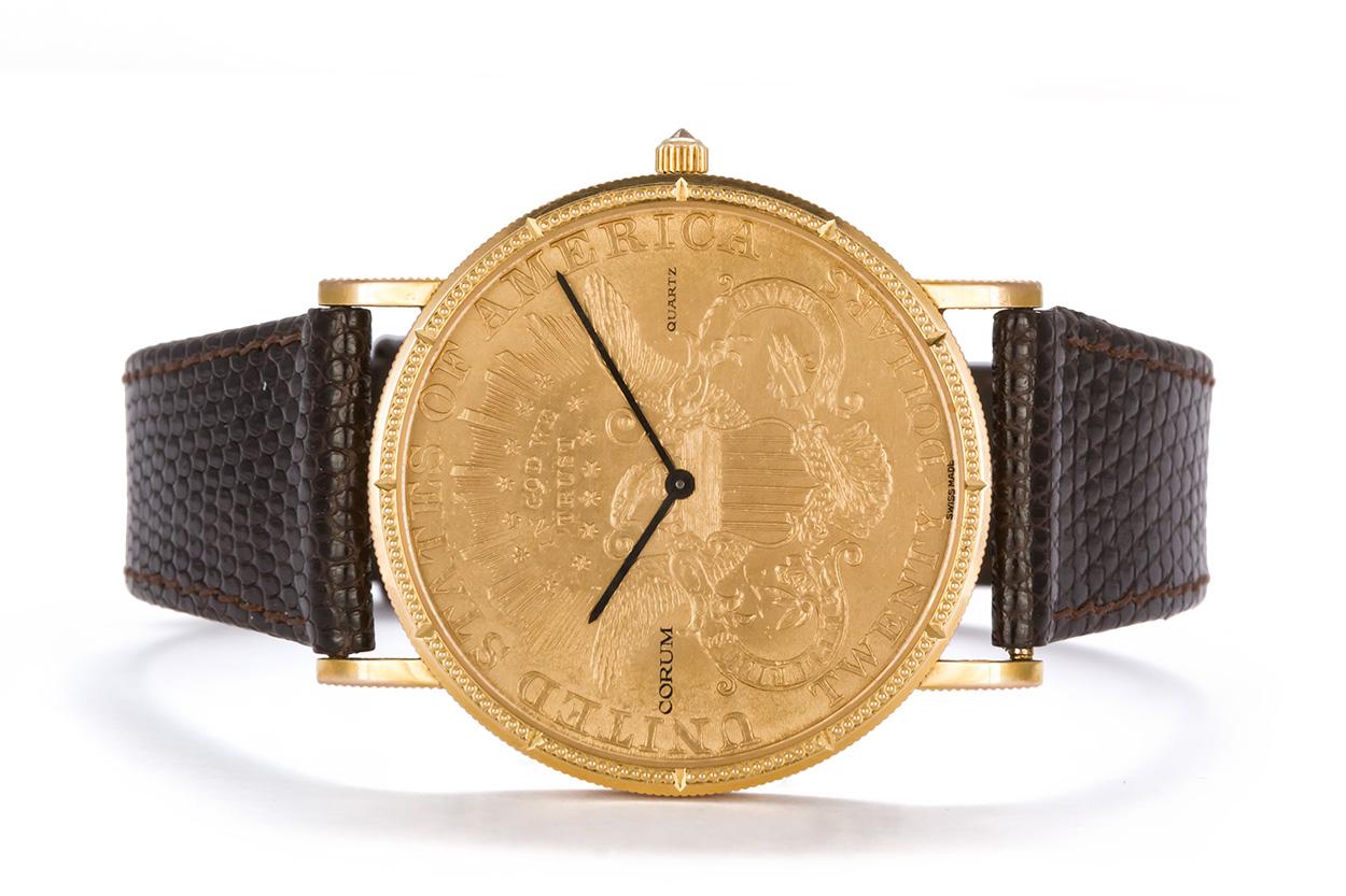 We are pleased to offer this Corum $20 1896 Gold Coin Mens Watch. It features a 18k yellow gold 1896 $20 gold coin set in a 35mm case, sapphire crystal, and quartz movement. The strap has been replaced with a gucci brown leather strap fitted with