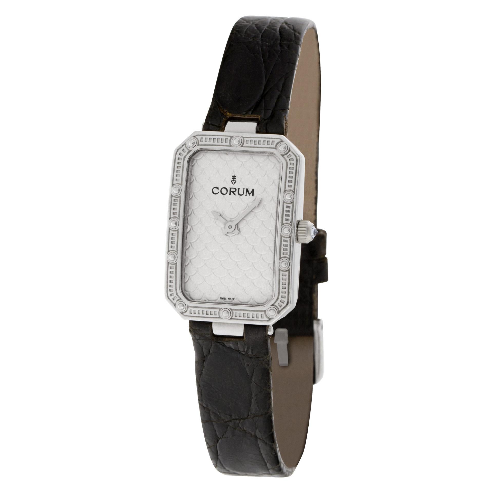 Ladies Corum in 18k white gold on a leather strap. Quartz. Case size 20mm x 28mm. With box and papers. Ref 24 706 59. Fine Pre-owned Corum Watch.   Certified preowned Corum 24 706 59 watch is made out of white gold on a Black Leather strap with a