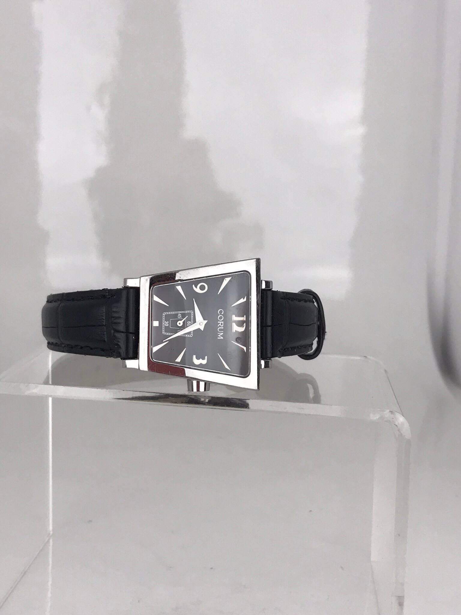 Corum Boutique Trapeze 105.404.20 Stainless Steel Black Ladies Watch. Circa 2010
Wrist size is 8.5 inches
GENUINE by Corum and 100% authentic 
Stainless Steel Case 
Quartz movement 
Black Dial 
Corum black leather bracelet and clasp 

The watch is