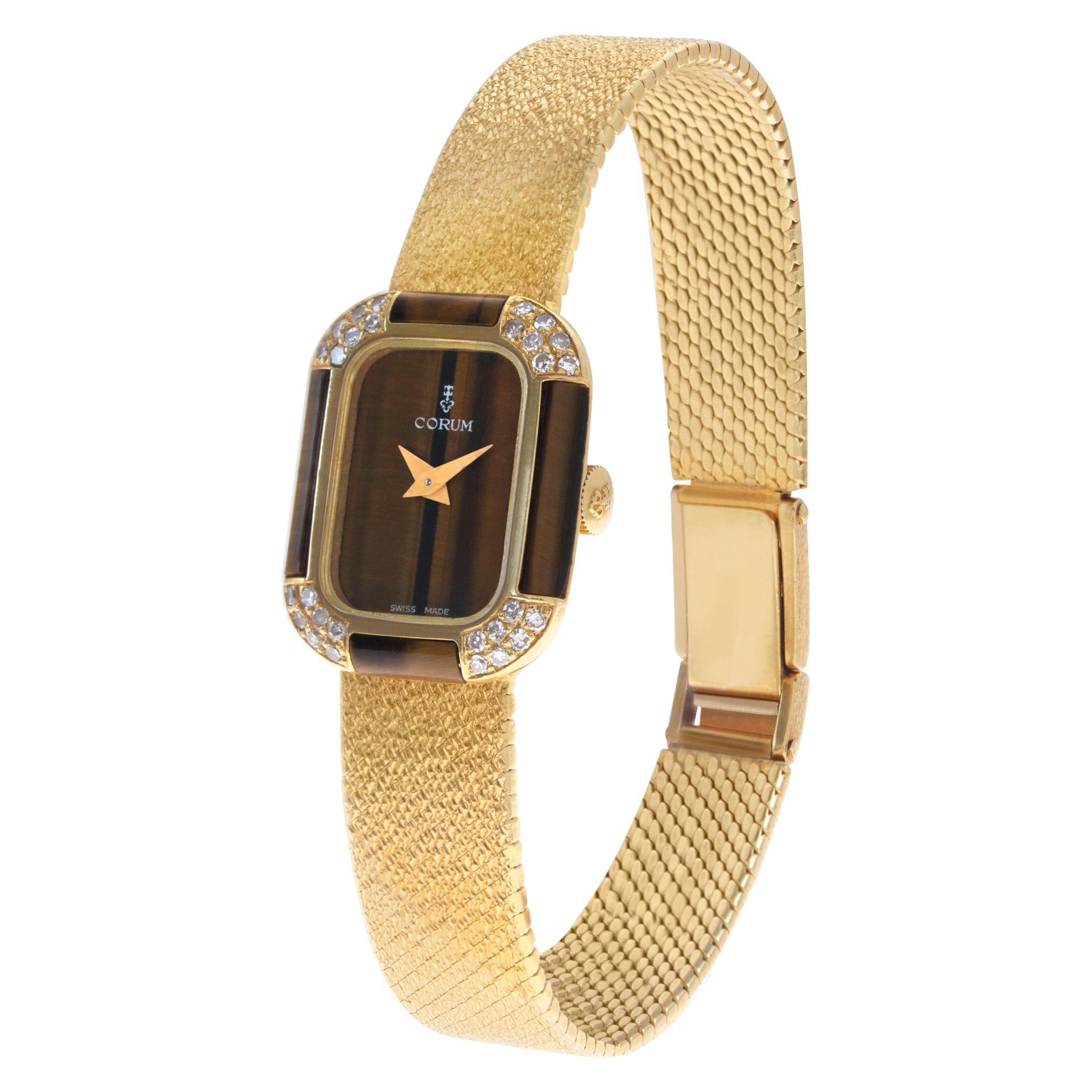 Corum Classic dress watch with tiger eye dial & case with diamond accents on the bezel. Fits 6 inches wrist. Manual wind. 18.5 mm case size. Ref 17142B47. Circa 1990s. Fine Pre-owned Corum Watch.

Certified preowned Dress Corum Classic 17142B47