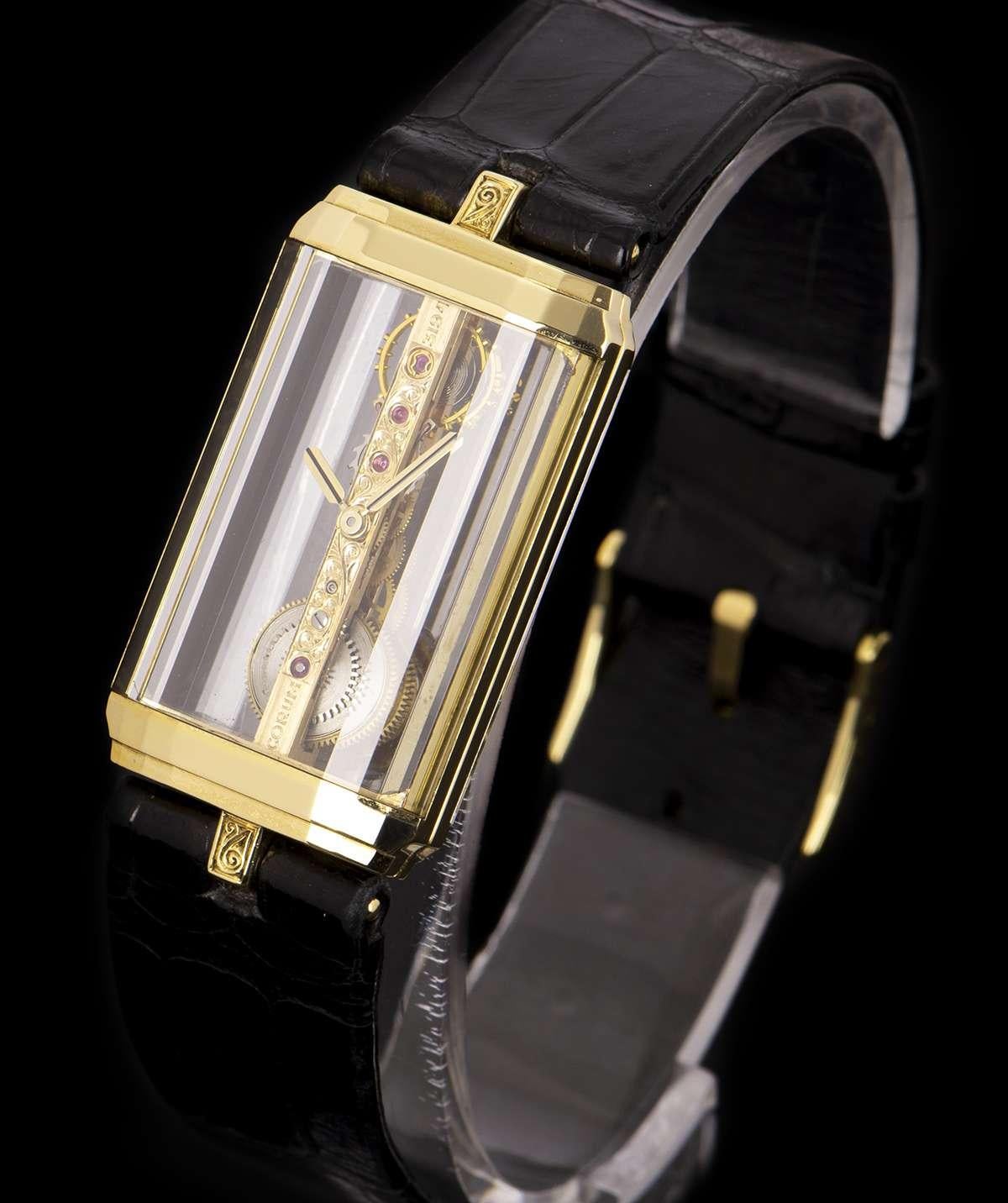 ​An 18k Yellow Gold Golden Bridge Mid-Size 20mm Wristwatch, skeleton dial with the iconic golden bridge, a fixed 18k yellow gold bezel, an original black leather strap with an original 18k yellow gold pin buckle, sapphire glass, exhibition caseback,