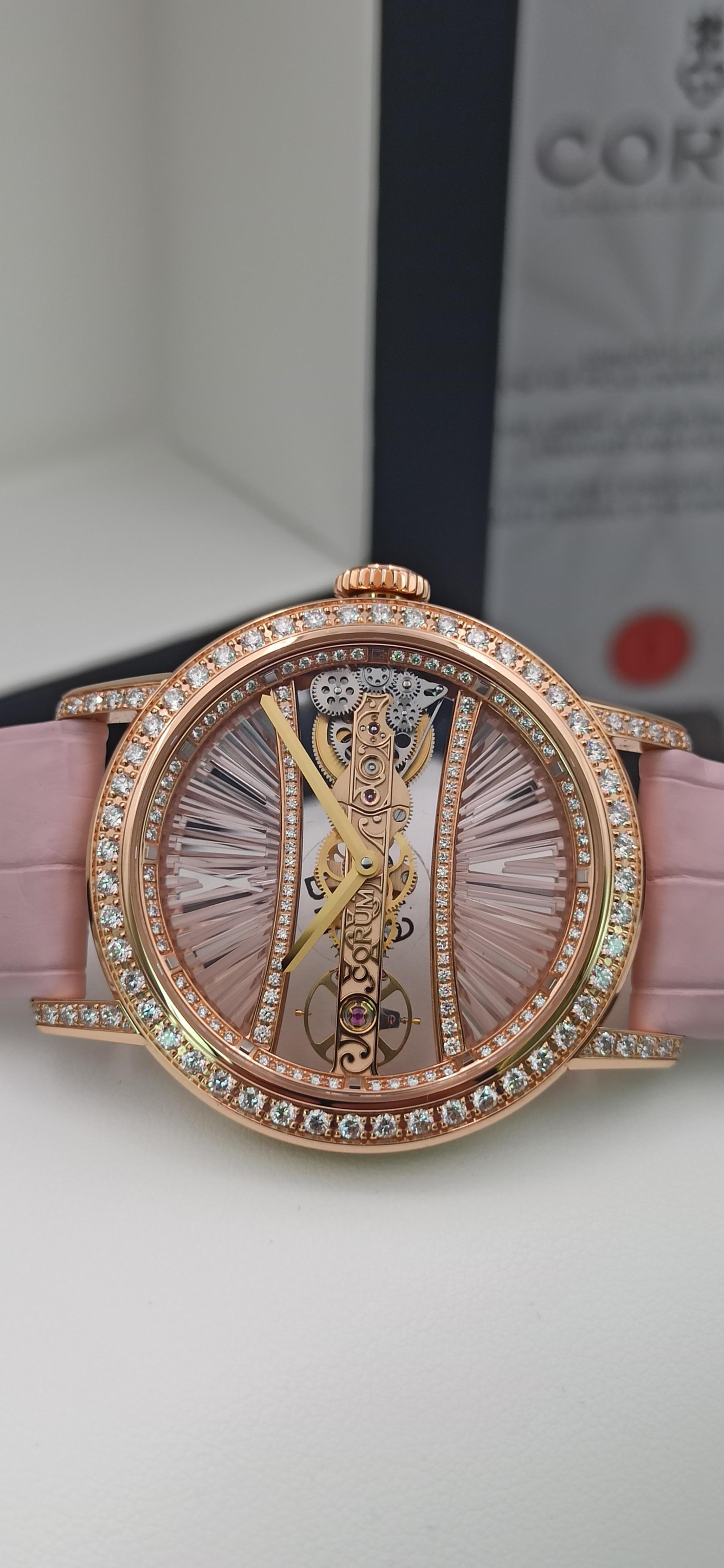 Corum Golden Bridge, round 39mm case,  18kt rose gold case and deployment buckle, 
complete with Box, Papers, Certificate.

Really an amazing lady wrist watch, that includes all the exclusivity, and perfection of the High End hand made Corum swiss