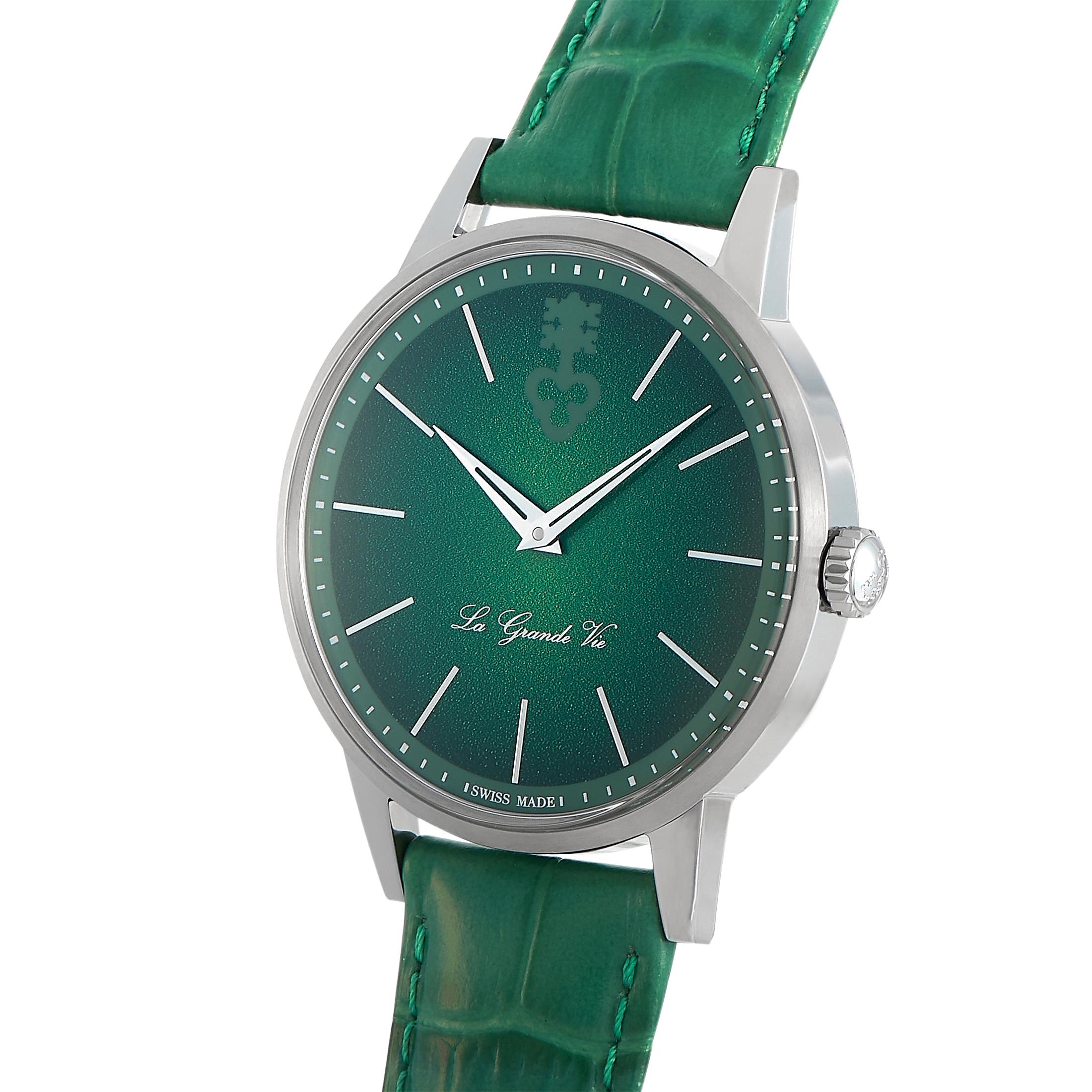 The Corum Heritage La Grande Vie watch, reference number 082.750.04/0057 LG007, is a member of the esteemed “Heritage” collection.
 
 This timepiece comes with a 42 mm titanium case that boasts see-through back. On the green dial, two central