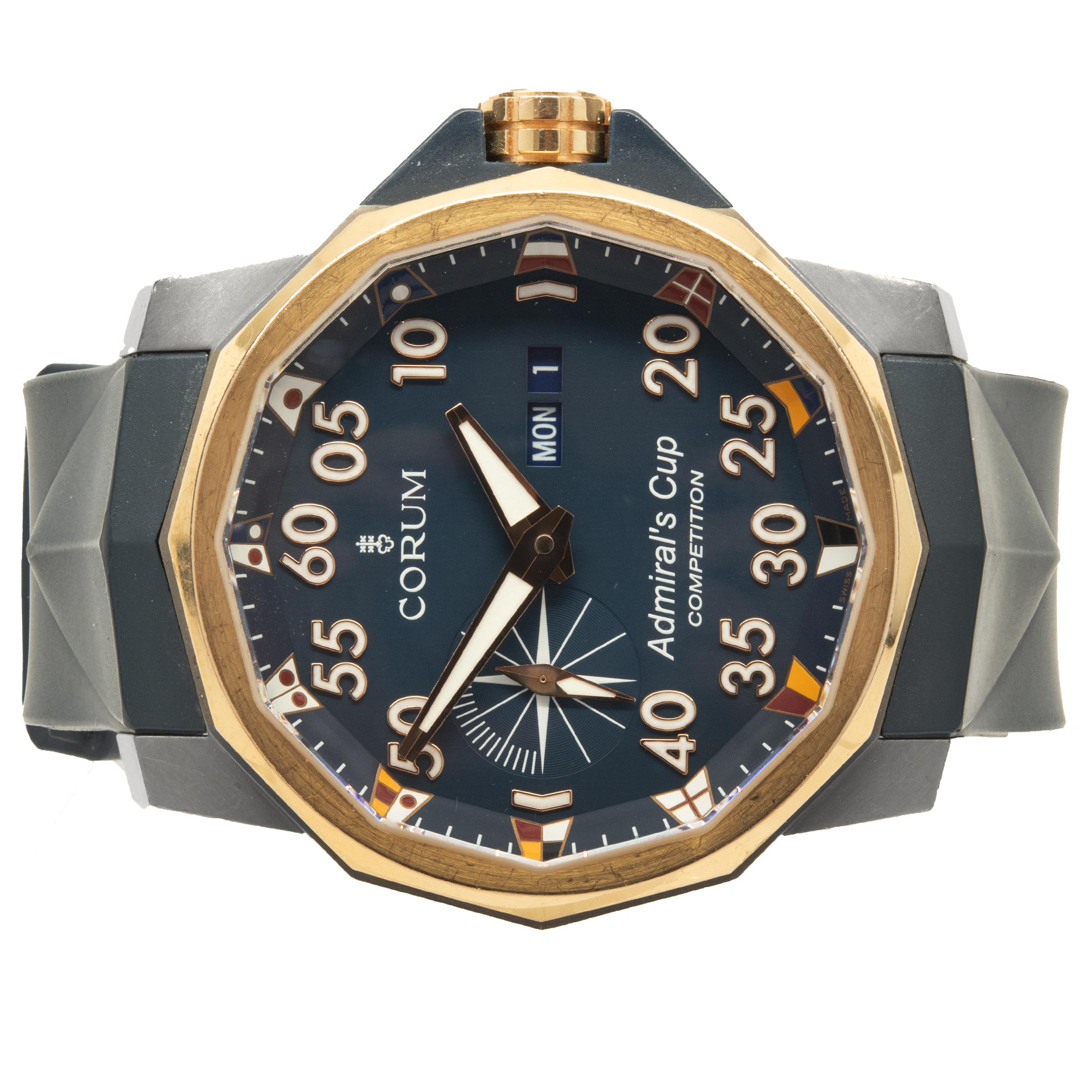 Movement: automatic
Function: hours, minutes, seconds, day, date
Case: 48mm titanium and 18K rose gold round case, sapphire crystal, push/pull crown
Band: blue rubber strap, Corum buckle
Dial: blue 
Serial #: 2106XXX
Reference #: 01.0002

Does not