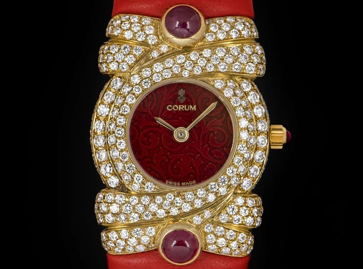 An Unworn 18k Yellow Gold Ladies NOS Dress 22mm Watch, red dial with filigree design, 18k yellow gold bezel, lugs and case set with approximately 240 round brilliant cut diamonds (~1.82ct), an original red leather cuff, sapphire glass, quartz
