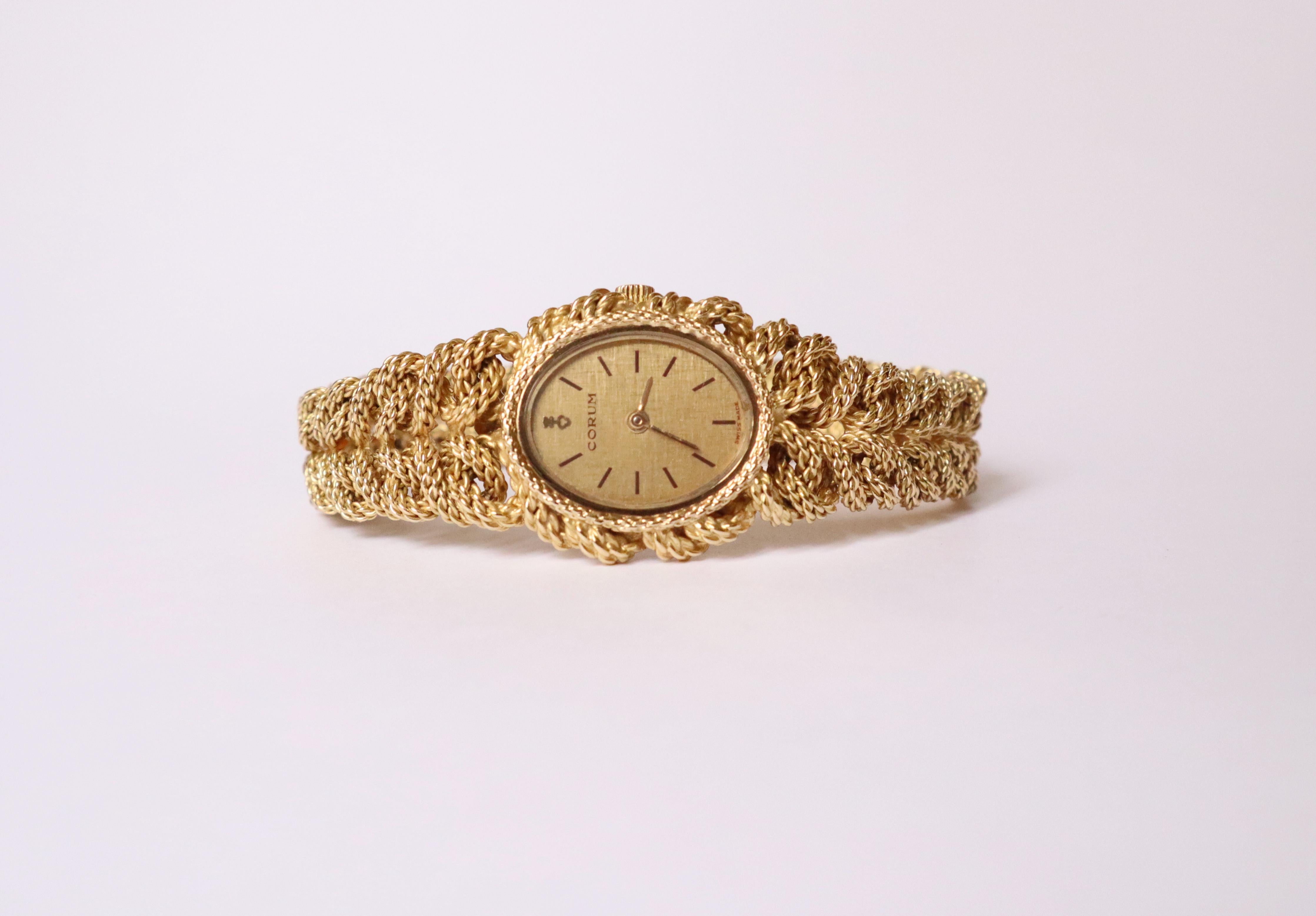 CORUM Oval lady's watch in 18 carat yellow gold. Stylized bezel. Oval case, snap closure bottom. Champagne dial with baton indexes. mechanical movement with manual winding. Bracelet in 18 carat yellow gold with clasp. 
Size: 21×20mm. 
Wrist: 16.4 to