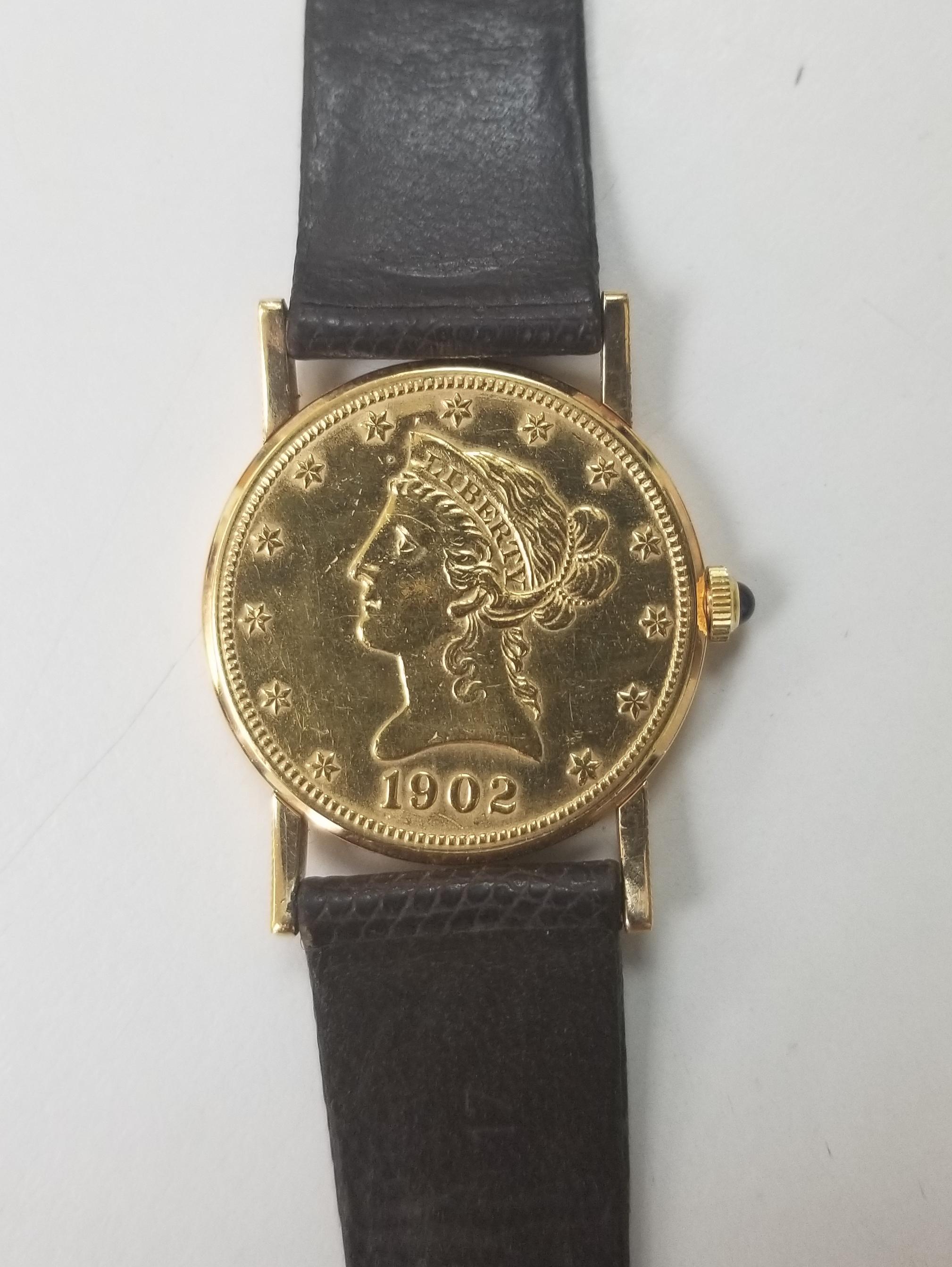 Corum Yellow Gold 10 Dollars Coin Diamond Ladies Watch Year 1902. Quartz movement. 18k yellow gold case with 22k coin 27.5 mm in diameter. Coin edge. Circular grained crown set with the diamond. Mineral glass crystal. Eagle 22K coin. Black button