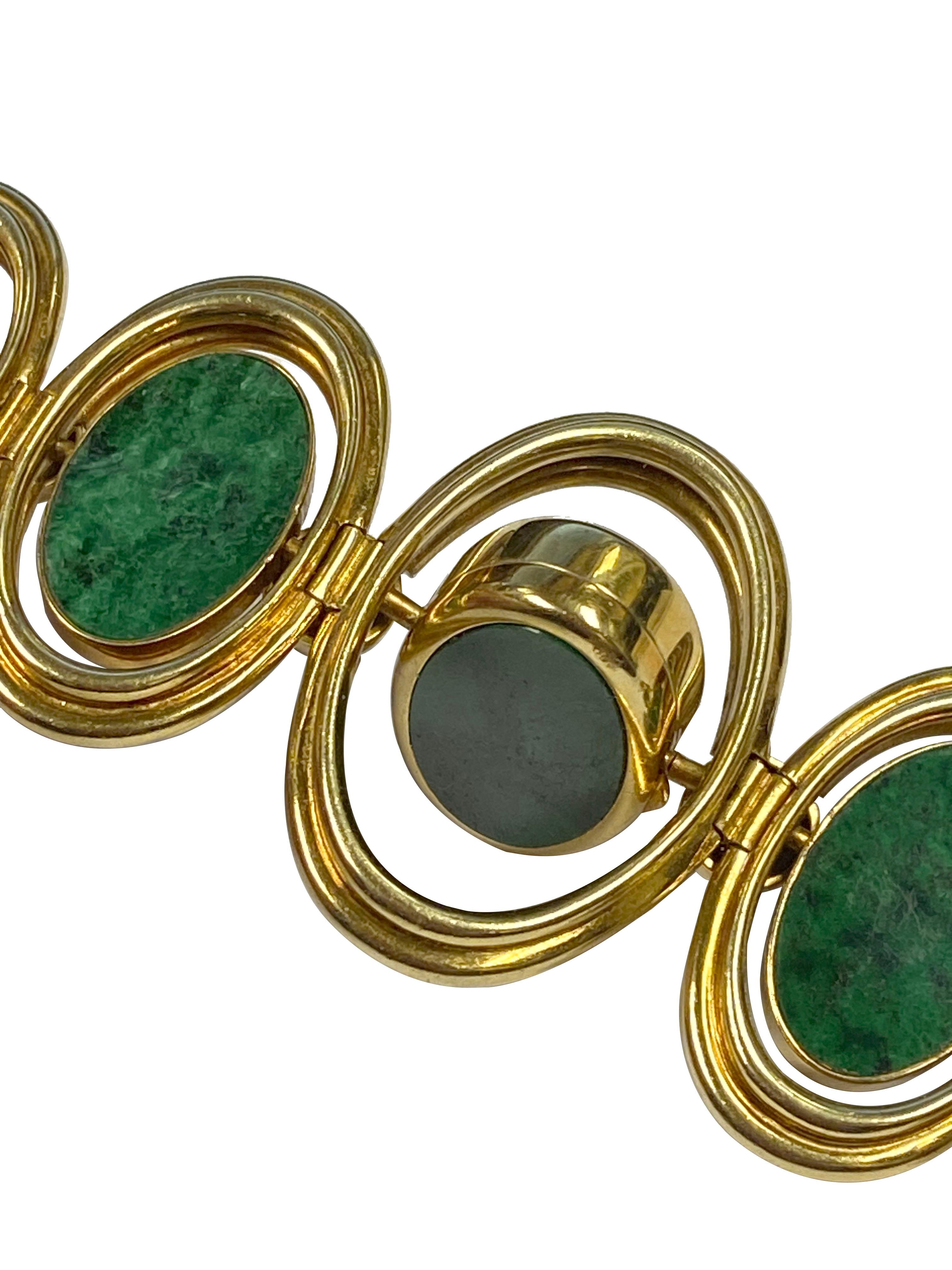 Circa 1980s Very Rare and unusual Corum Bracelet Wrist Watch with reversible center sections so the watch can be worn with all Tiger Eye facing up or all Malachite or a combination of both. 18k Yellow Gold and measuring 6 5/8 inches in length, the