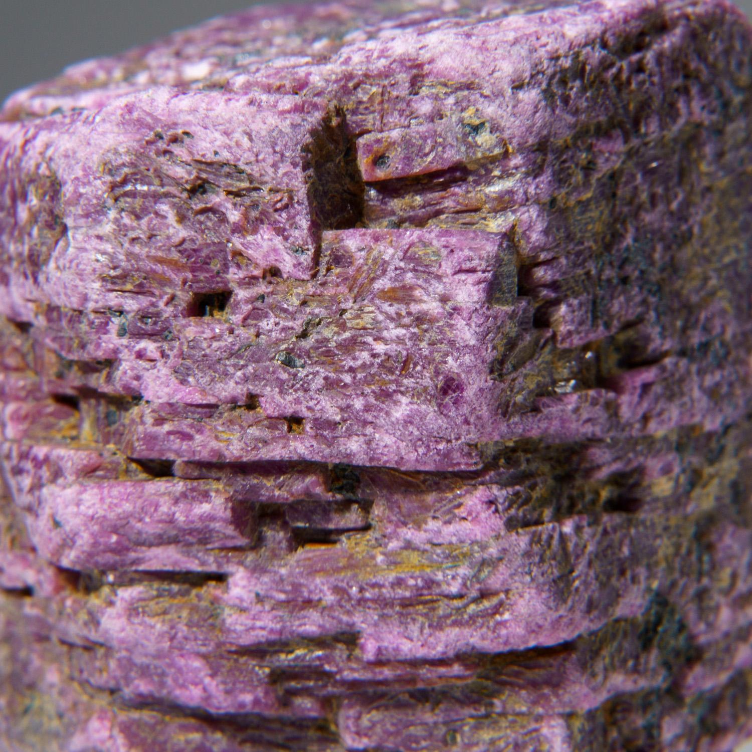From Mysuru (formerly Mysore), Karnataka, India

Translucent pink ruby crystal, the pink gem variety of the mineral species corundum, with remnants of greenish kyanite matrix included on the surfaces. The prism faces of the crystal have many minute