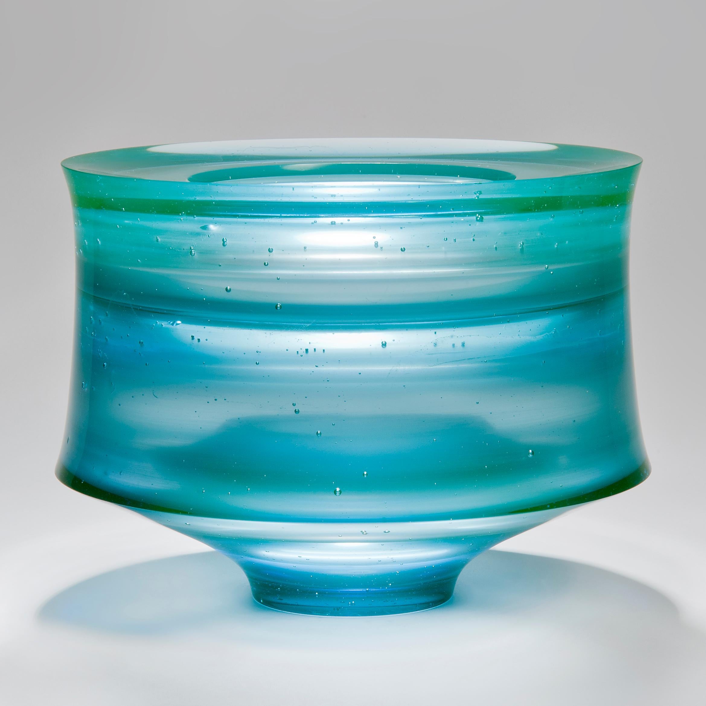 Corymb is a cast glass artwork in a beautiful soft aqua / turquoise blue by the British artist Paul Stopler. With a smooth exterior, the interior is stepped into sections by ridged protruding 