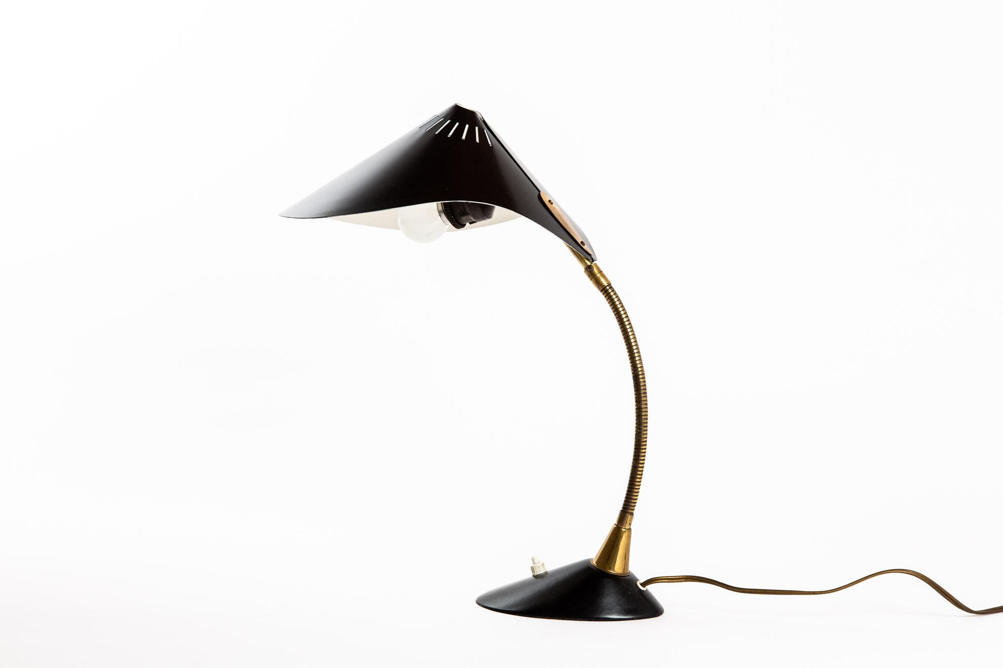 A Cosack table lamp. The standard can be deflected and is flexible. The base is very heavy for good stability. Thin black hat white inside.