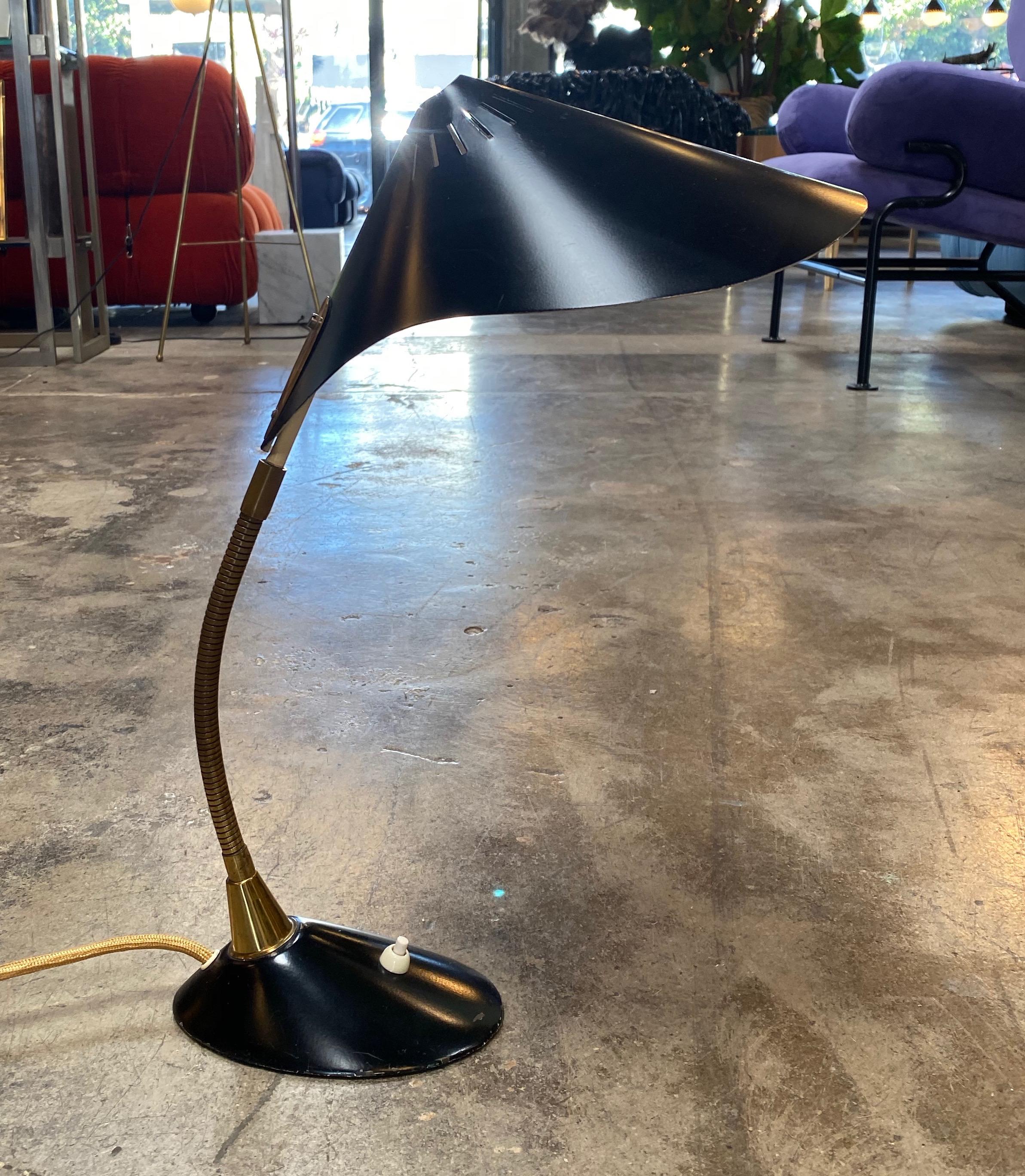 A Cosack table lamp 1959. The standard can be deflected and is flexible. The base is very heavy for good stability. Thin black hat white inside.
