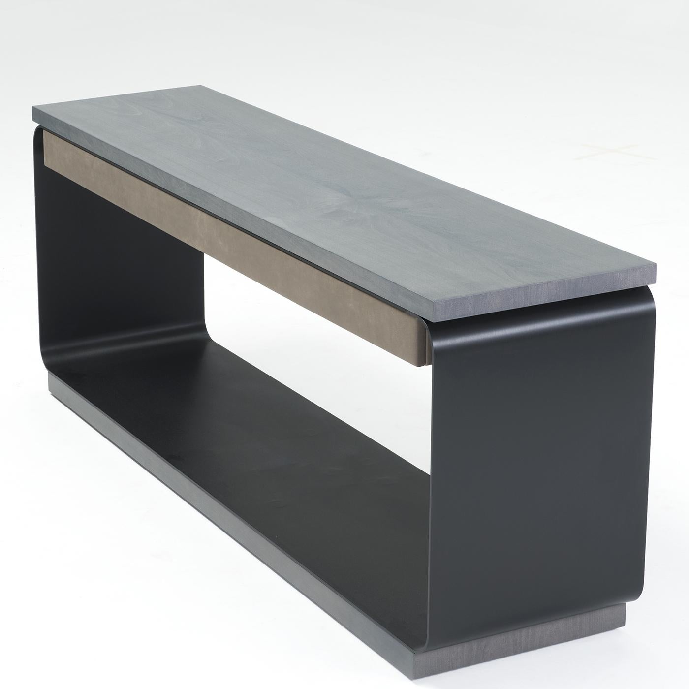 This minimalist console is composed of a satin anodized aluminum structure in burnt black, along with a charcoal maple wood base and three aligned drawers in genuine leather, for an interesting contrast in texture and touch. This sleek, elegant item