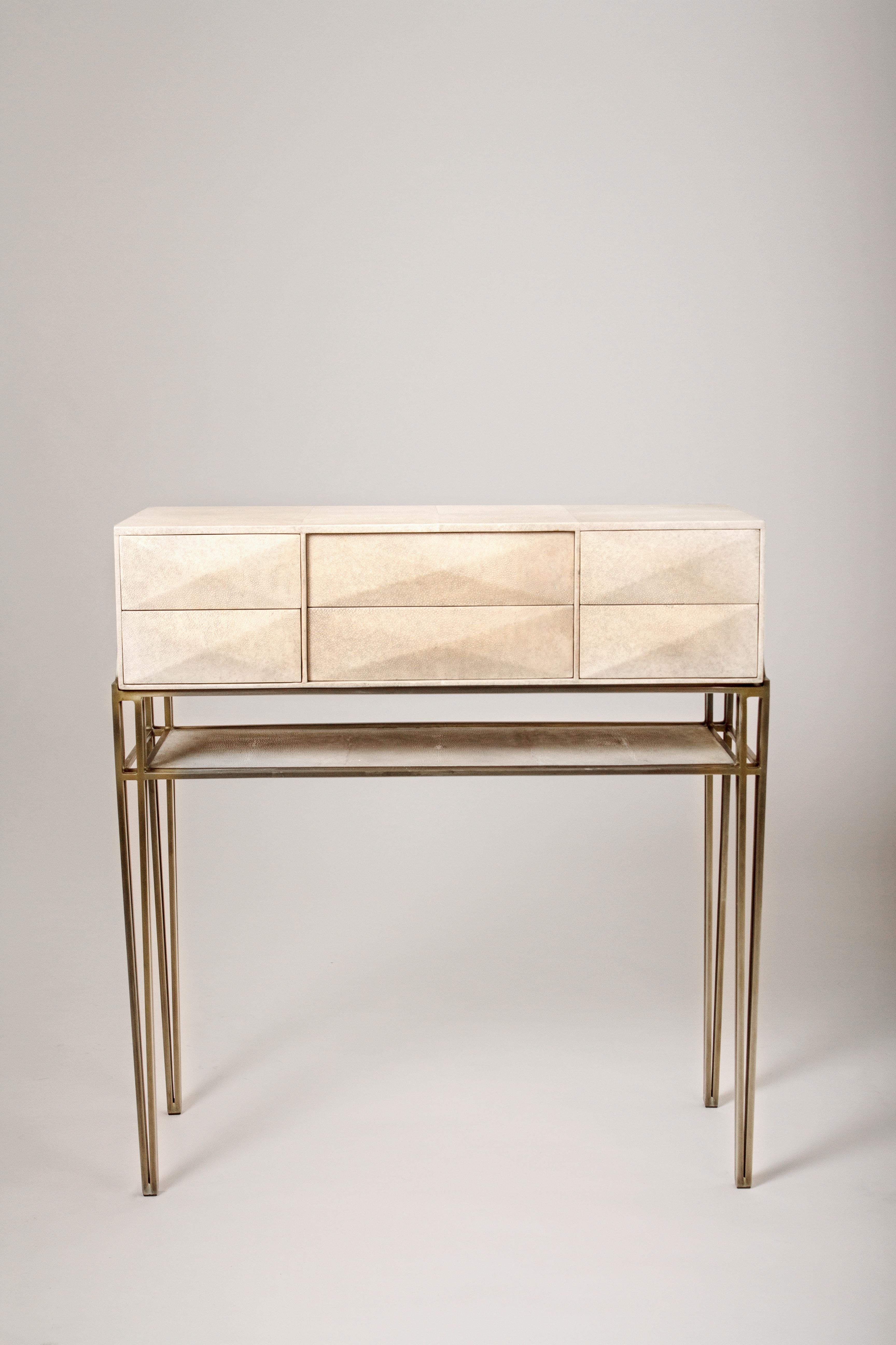 The Cosima 8 console is an updated version of the Cosima 7 console (see image at end of slide). This console inlaid in cream shagreen includes 6 beveled push-through geometric drawers that can used to store anything from jewelry to stationary. This