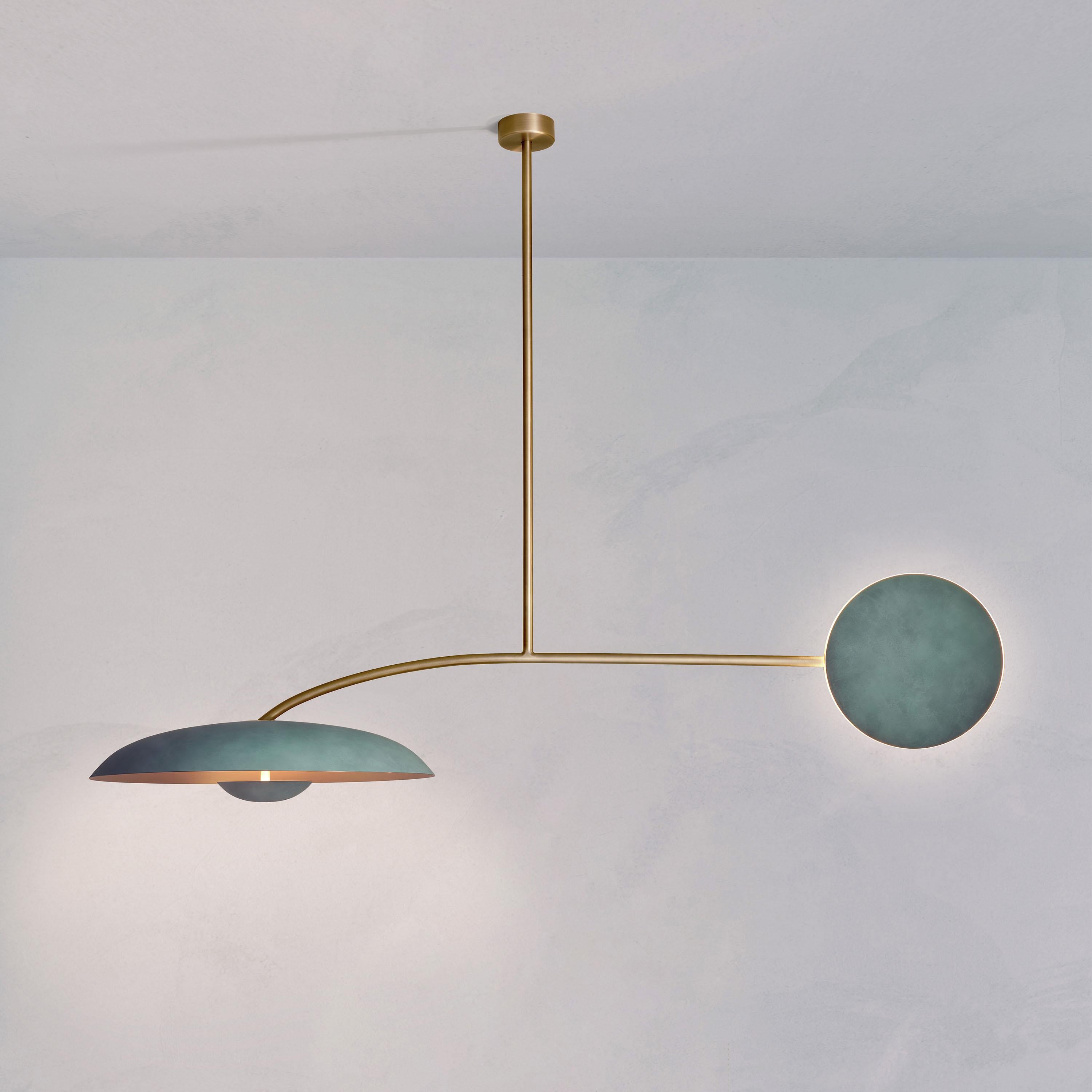 Inspired by planet-like shapes and textures, the Cosmic collection plays with both metal properties and a selection of patina finishes. Two lighting components are harmoniously balanced. 

Composed of patinated brass plates and a finely brushed