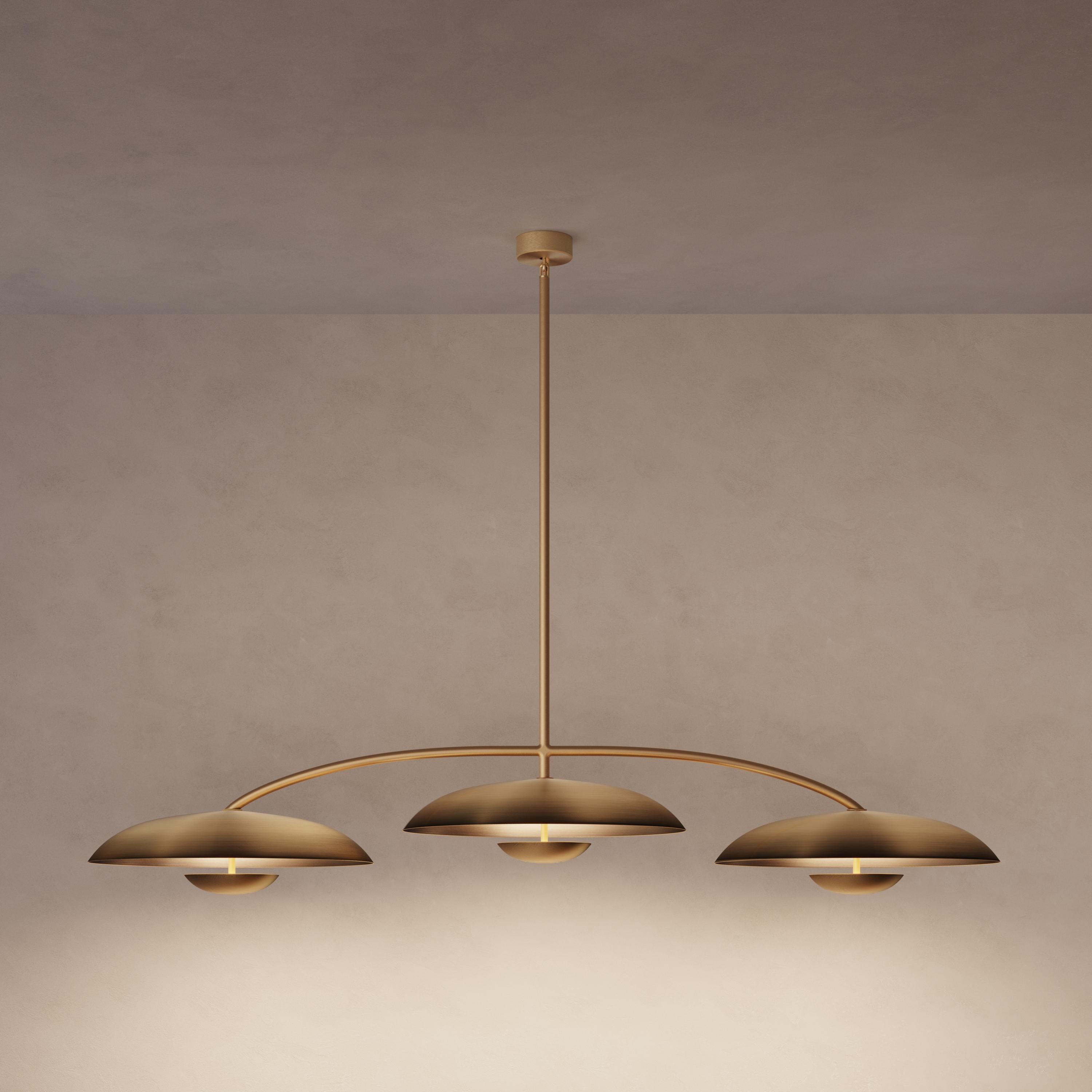 Trio for three, a unique ceiling light composed by a cluster of lighting components. Combining patinated brass plates and finely brushed brass framework, the Orbit Trio ceiling light is softly illuminated with LED elements from within.
 
This