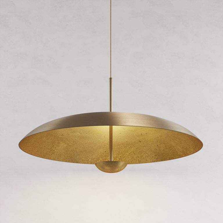 Two finely hand-spun brass plates make up this pendant light, finished in a mixed patina to create this unique appearance. Please note the process is random and each plate has a slightly variant finish. The light is projected into the shade and