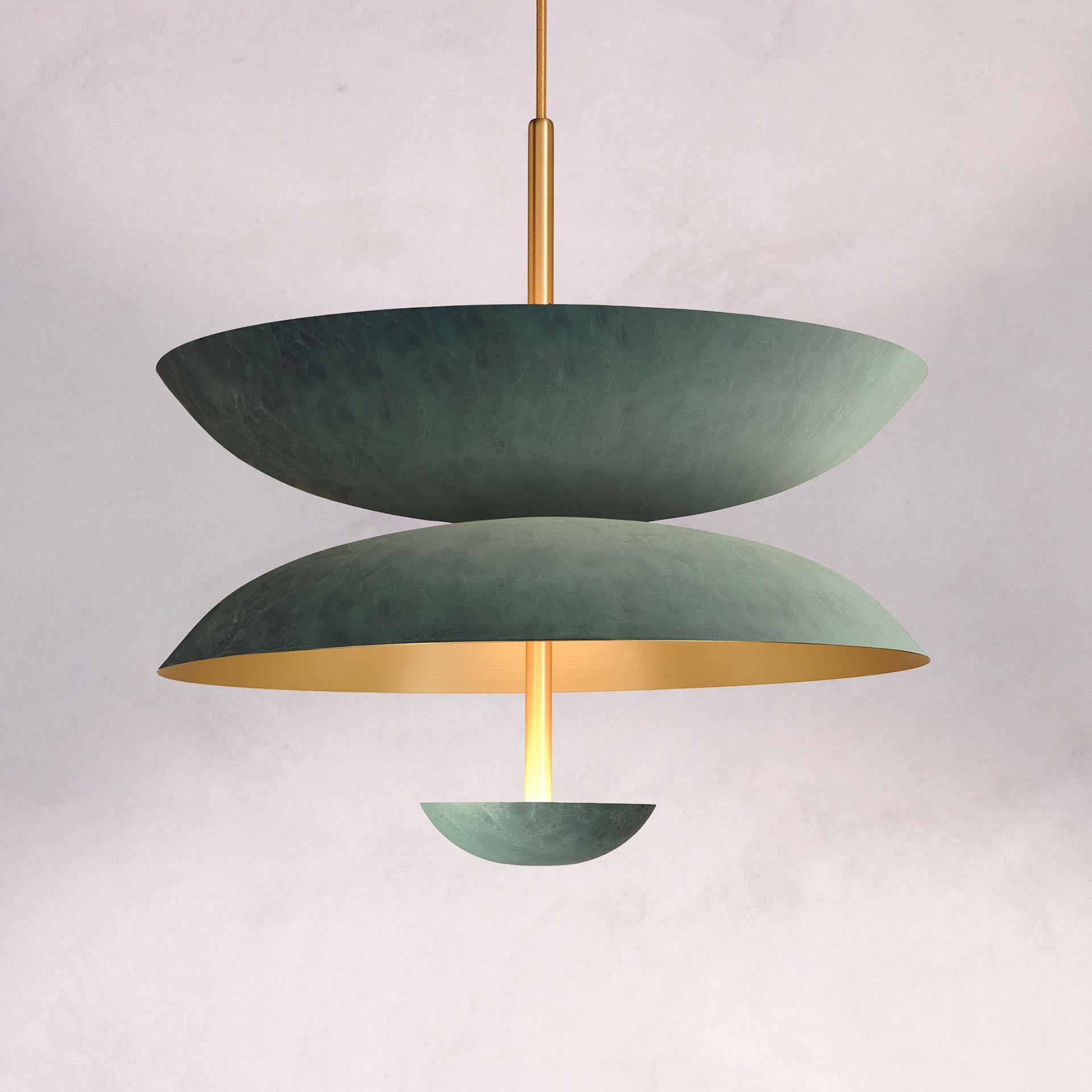 Inspired by planet-like shapes and textures, the Cosmic collection plays with both metal properties and a selection of patina finishes.
 
The Pendant Duo Verdigris is composed of three carefully hand-spun brass plates and preserves the beautiful