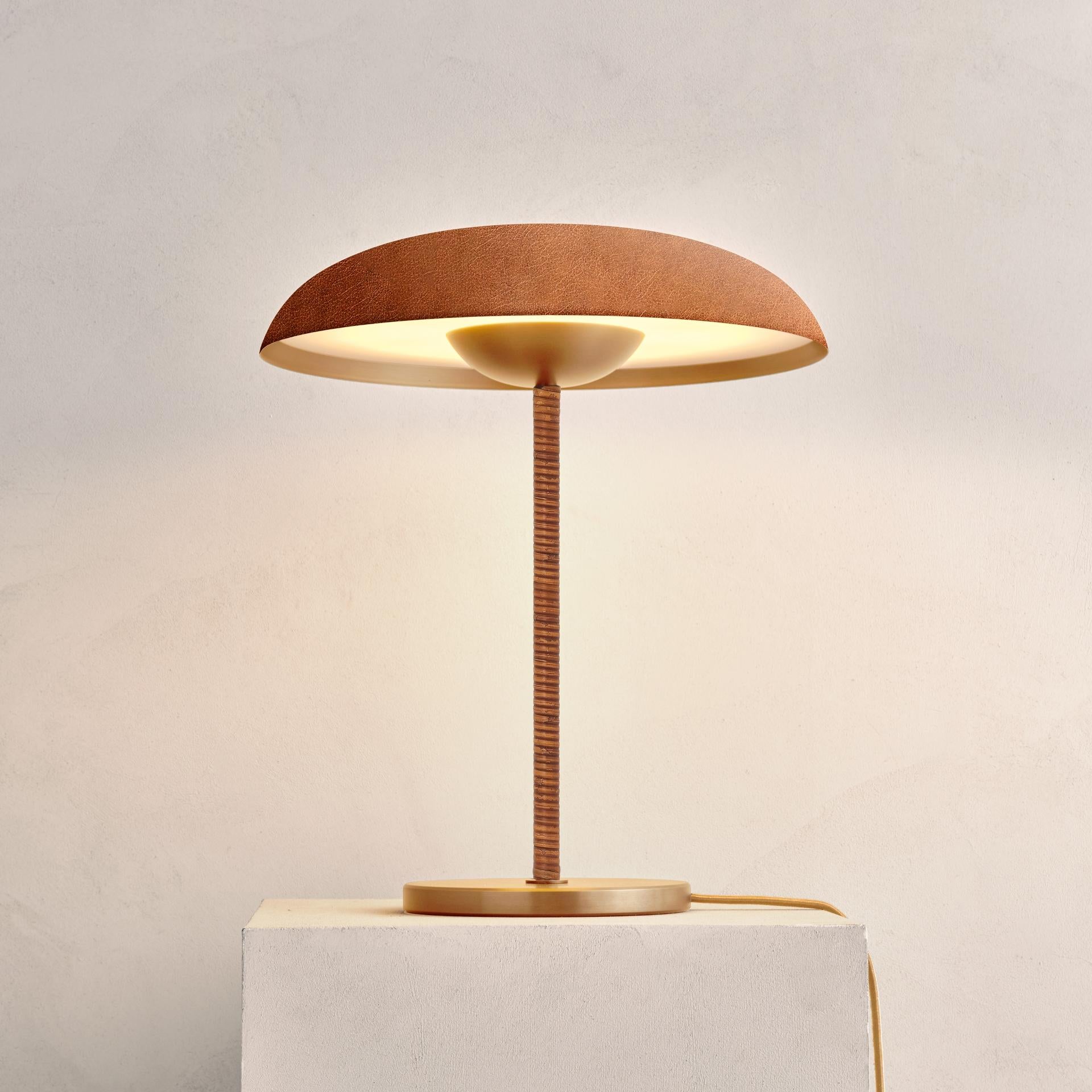Taking inspiration from planetary shapes and textures, the Cosmic collection artfully explores the interplay of metal properties and a curated selection of patina finishes.
 
Handcrafted with a finely brushed brass shade and framework, and a leather