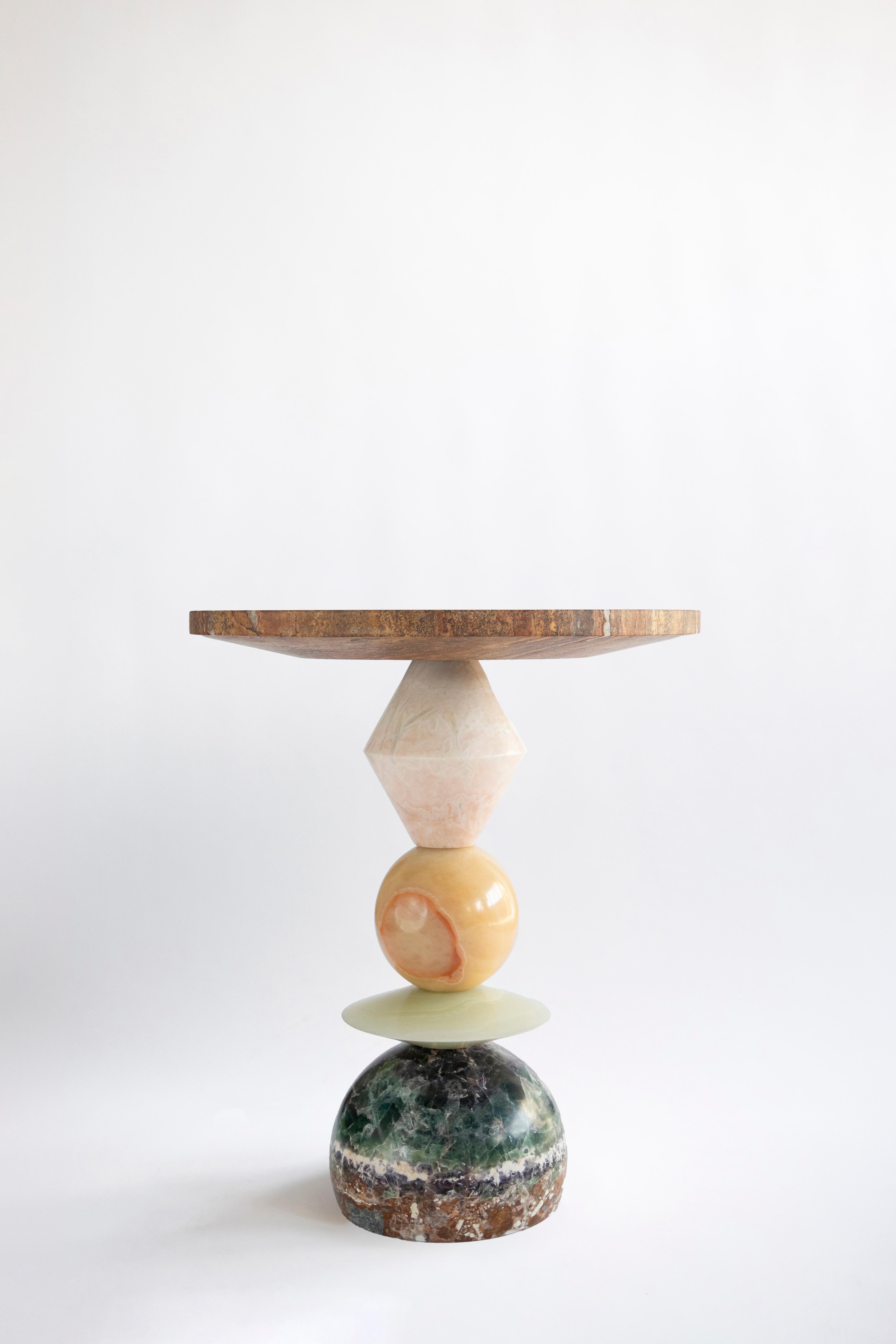 Materials: Fluorite, green onyx, pineapple onyx, pink onyx, red travertine
Indoors
Hand crafted Side table
Made in Mexico

Inspired by the enduring legacy of observing the cosmos, 'Cosmic Traces' evolves from the essence of 'Cosmic Relics.' While