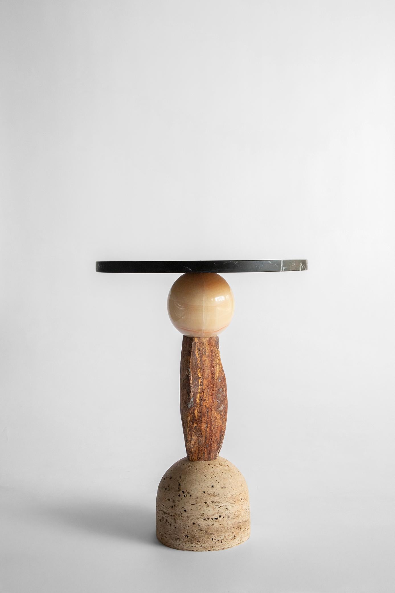 Materials: Travertine, red travertine, pineapple onyx, black Queretaro marble.
Hand crafted Side table
For indoors

Inspired by the enduring legacy of observing the cosmos, 'Cosmic Traces' evolves from the essence of 'Cosmic Relics.' While totems