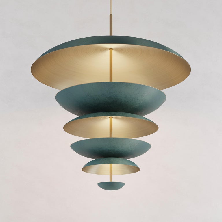 Made with finely hand-spun brass plates in London. The outer shades of this chandelier are finished in a mixed verdigris patina whilst the inner shades are kept in finely brushed brass. Light is projected into the shade and reflects out,