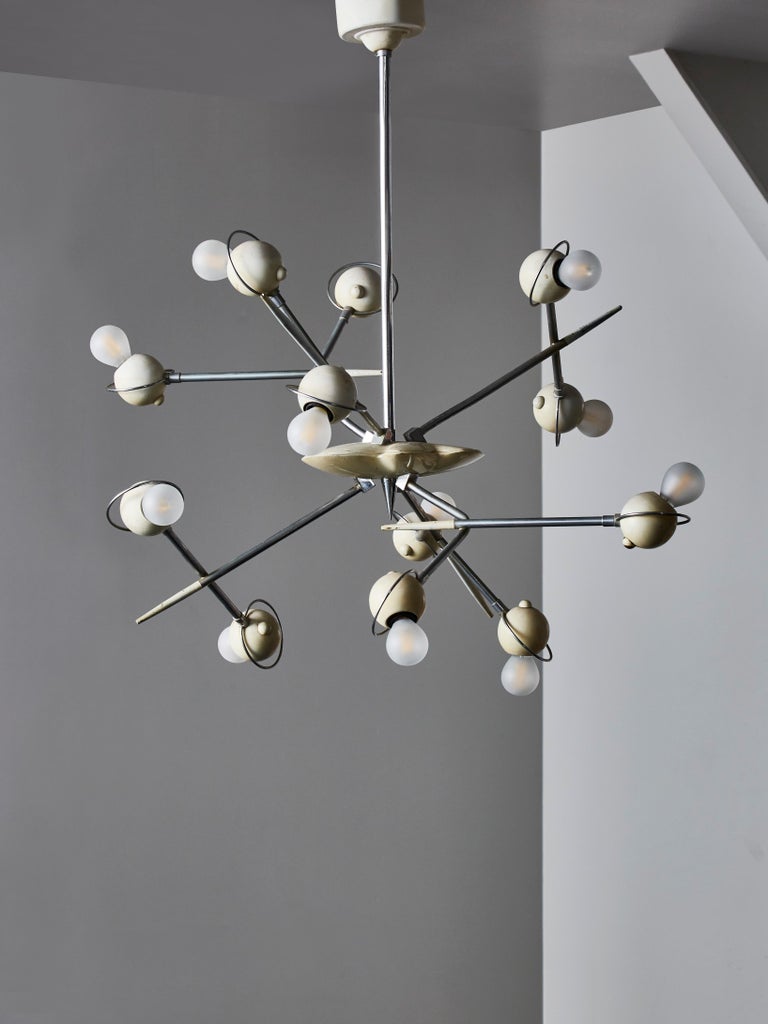 Unique looking Cosmo chandelier designed by Oscar Torlasco for Lumi in the 1960s.

This chandelier has twelve randomly placed arms of light and is made of lacquered aluminium and nickeled brass.

Good vintage condition.