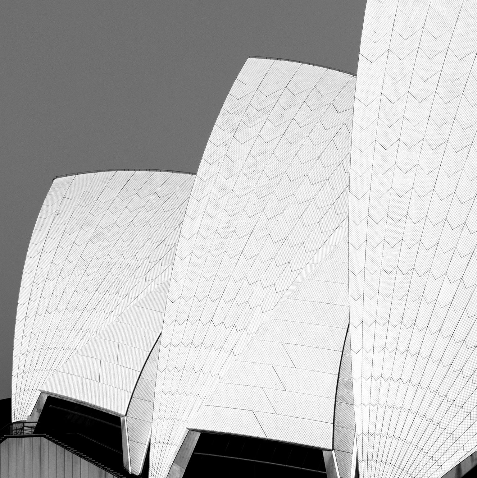 Photograph by Cosmo Condina of a toned architectural graphic view in black and white of the Sydney Opera House.
 Archival Pigment Print, 19” X 9”, Edition of 10. This is #3/10 in the edition.
 
This is a graphic view of the Sydney Opera House, a