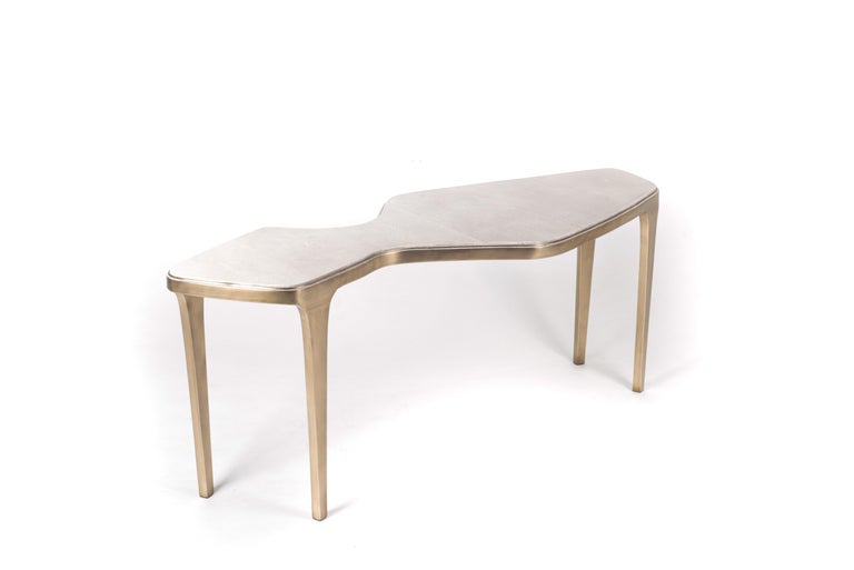 The cosmos nesting coffee table large is both Minimalist and dramatic. The top is inlaid in celadon shagreen, that is hand-dyed by artisans, and completed with bronze-patina brass. The designer calls this finish 