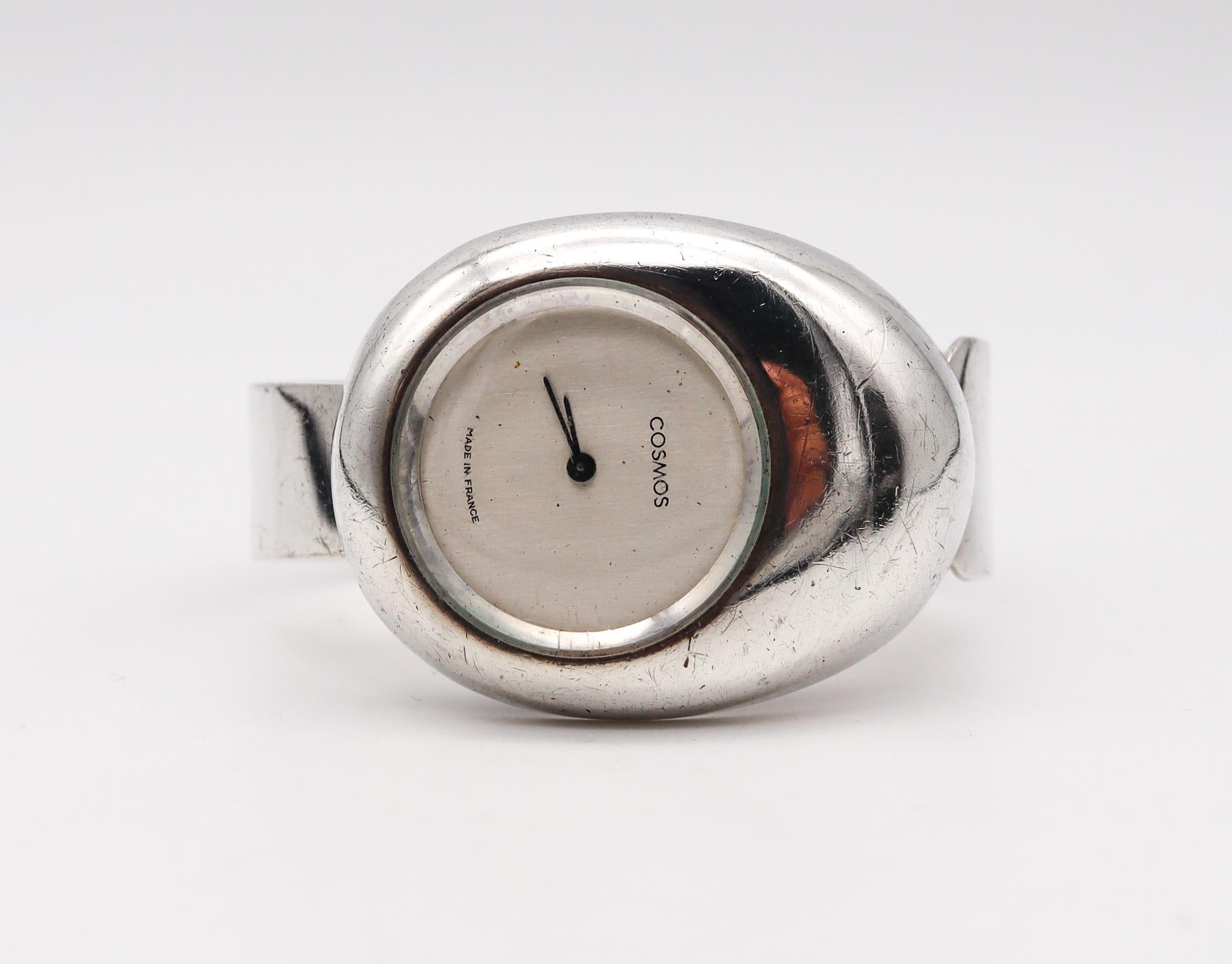 A retro wrist watch cuff designed by Cosmos Paris.

Beautiful vintage cuff bracelet wristwatch, created in Paris France by Cosmos, back in the 1973. This sculptural retro piece has been crafted with space era patterns in solid sterling silver