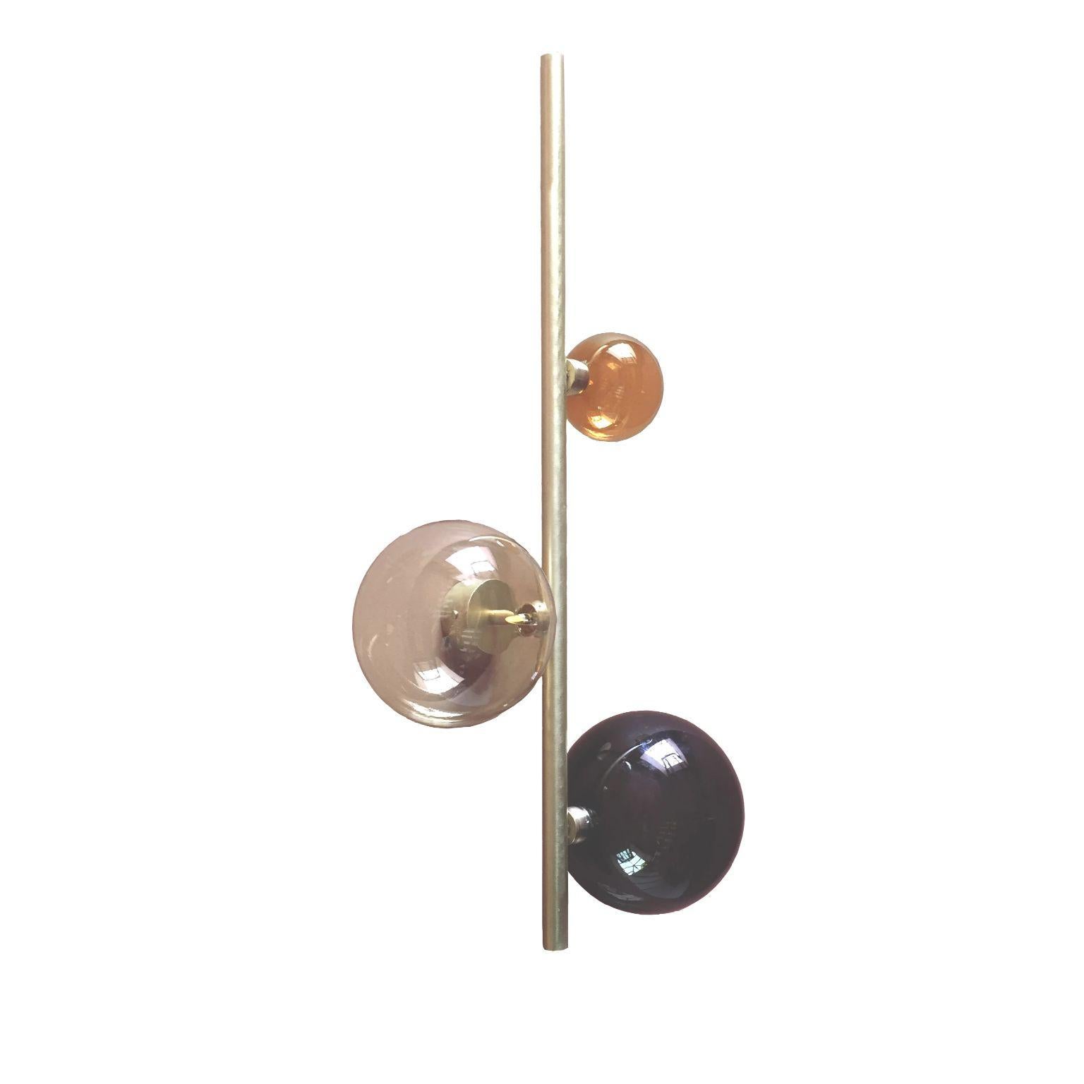 Cosmos sconce #3 by Emilie Lemardeley
Dimensions: D19 x W37 x H70 cm
Materials: brushed brass, 3 glass spheres
Weight: 3 kg

The cosmos collection references to the old occidental belief that the Earth was the center of the universe. During all