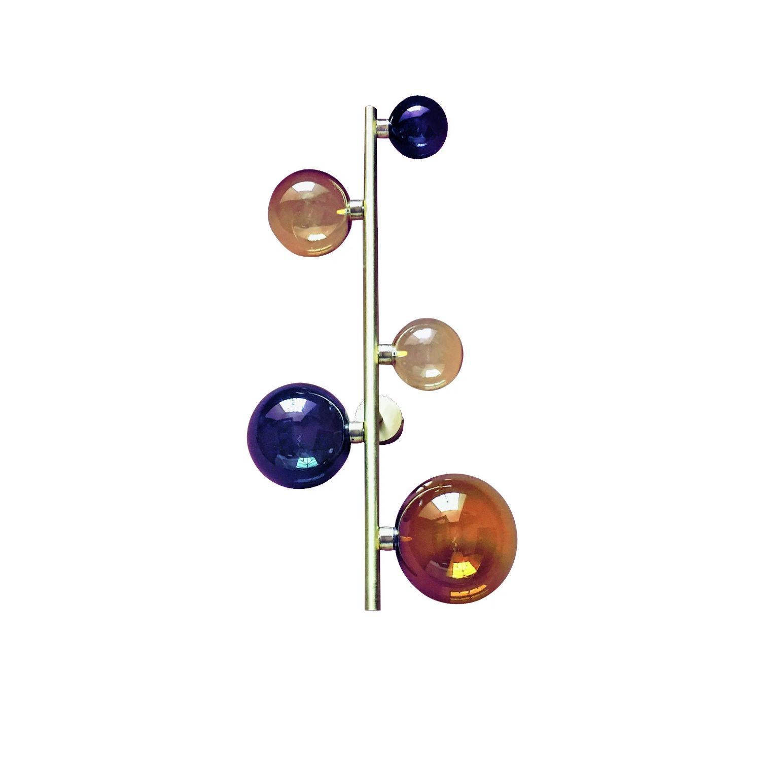 Cosmos sconce #5 by Emilie Lemardeley
Dimensions: D19 x W37 x H70 cm
Materials: brushed brass, 5 glass spheres
Weight: 4 kg

The cosmos collection references to the old occidental belief that the Earth was the center of the universe. During all