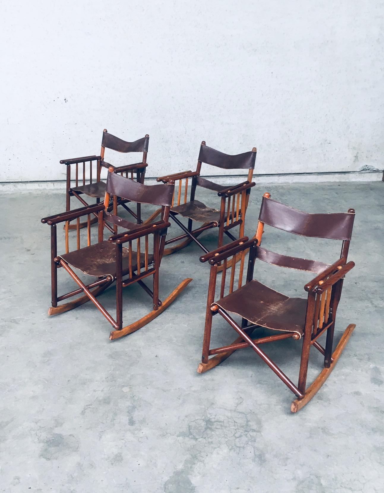 Vintage Original Midcentury Costa Rican Folding Safari Campaign rocking chair set of 4. Made in Costa Rica, 1950's / 60's. Exotic hardwood constructed frame with brown leather straps for back support and brown leather seat. the chairs have been well