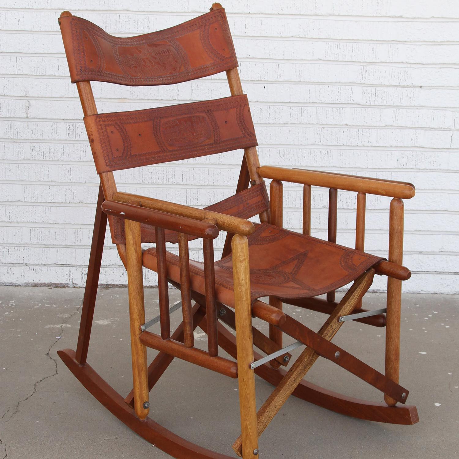 Costa Rican Rocking Chair

 Mid-Century Modern campaign rocking chair from the 1970s.
Teak cylindrical frame with unique spindle sides and double wide armrests.
Leather is embossed  on the backrest  and seat.
In very good condition with a beautiful