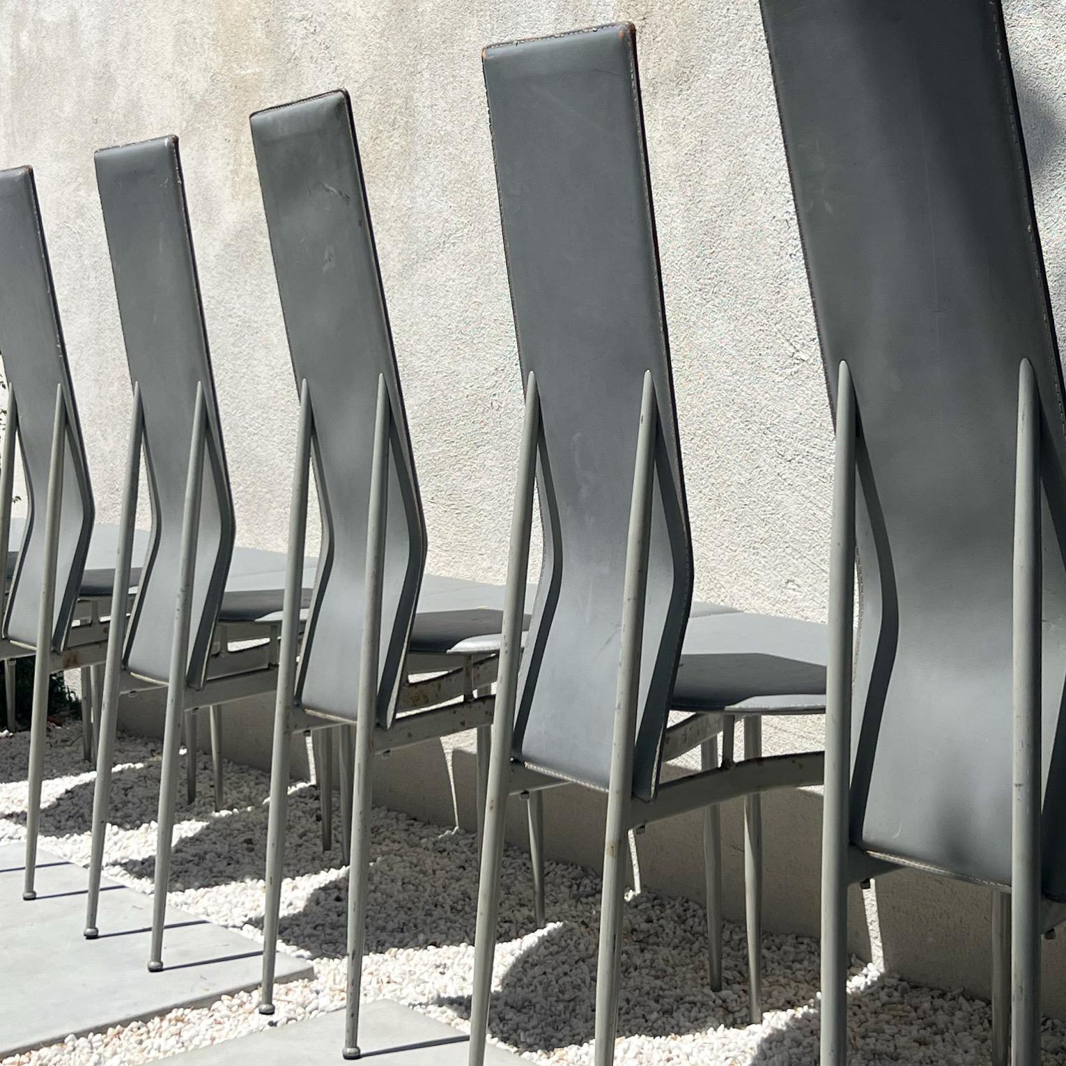 A set of eight fabulously sculptural postmodern dining chairs in fog gray, late 1970s. D’après Pietro Costantini or Ello Furniture. Metal frames with leather seats. Some signs of age like the best of us (see pictures); priced accordingly. Please
