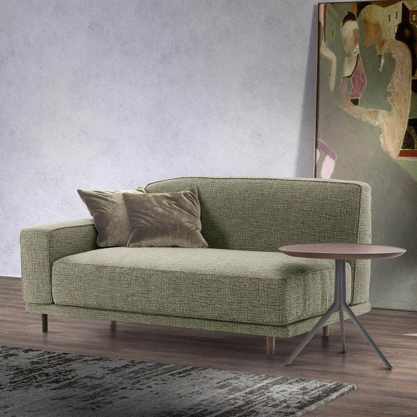 Designed by Marco Corti, this sofa boasts a wooden frame complemented by solid walnut canaletto details, adding a touch of sophistication to its sleek design. The cushions, armrests, and backrests are upholstered can be customized with leather, faux