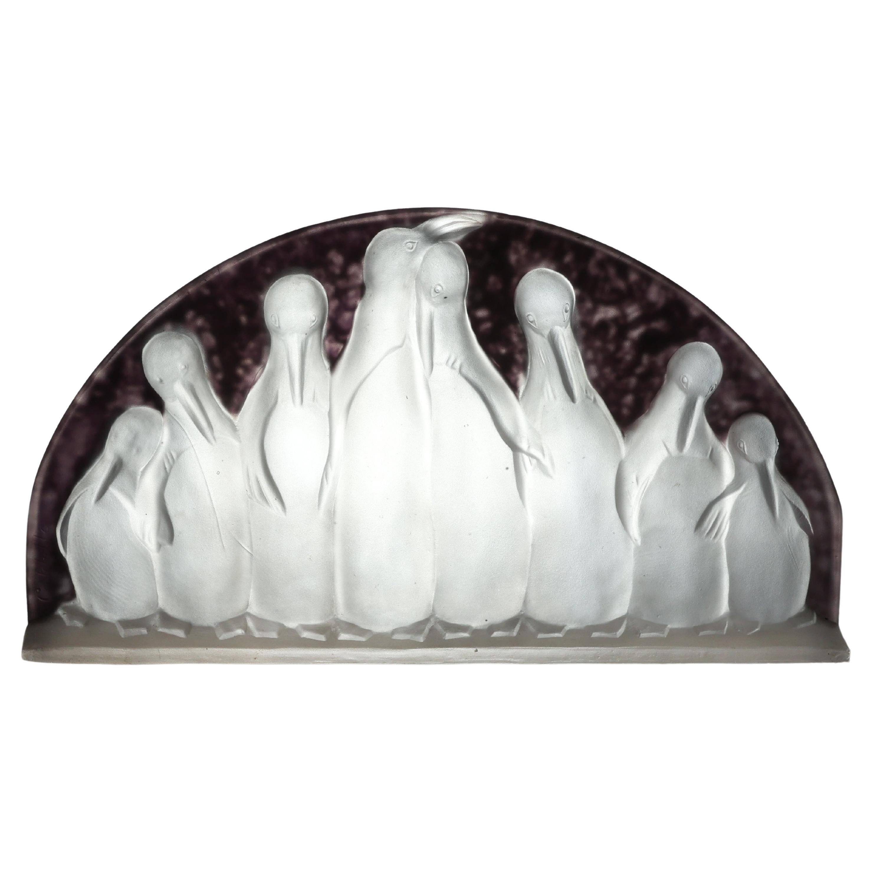 Costebelle. An Art Deco frosted opalescent half-moon glasswork with penguins