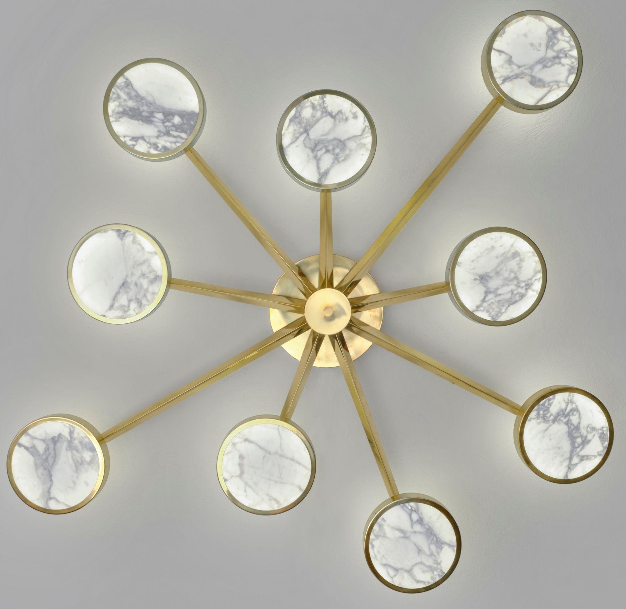 Costellazione is the new group of chandeliers in the Sistema collection. This is the 9 arms version. Solid brass frame and thin cut luxury Calacatta translucent marble diffuser . Calacatta has been chosen for the warm veining and pure white