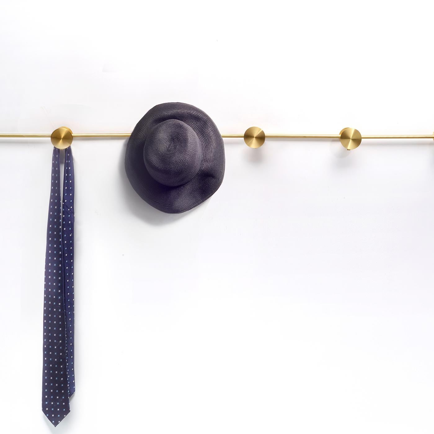 Inspired by the vintage accordion wooden coat hanger, this coat rack is made of polished brass with a flexible structure that can be shaped to suit interior needs and individual aesthetics. This modern design features six small knobs (6 cm) with a